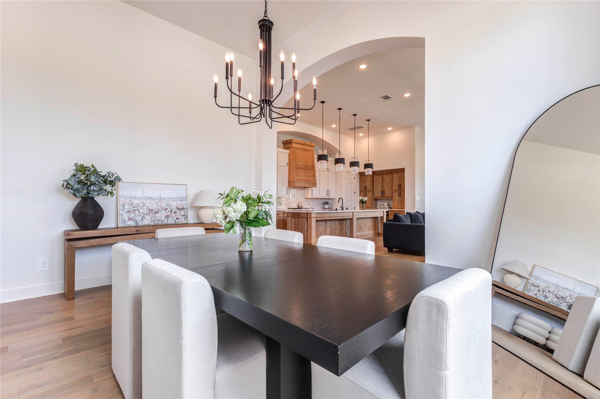 4510 Windmill Landing Lane, Fulshear, TX 77441 Modern dining area with a stylish chandelier. The space features an open layout leading to a bright kitchen.