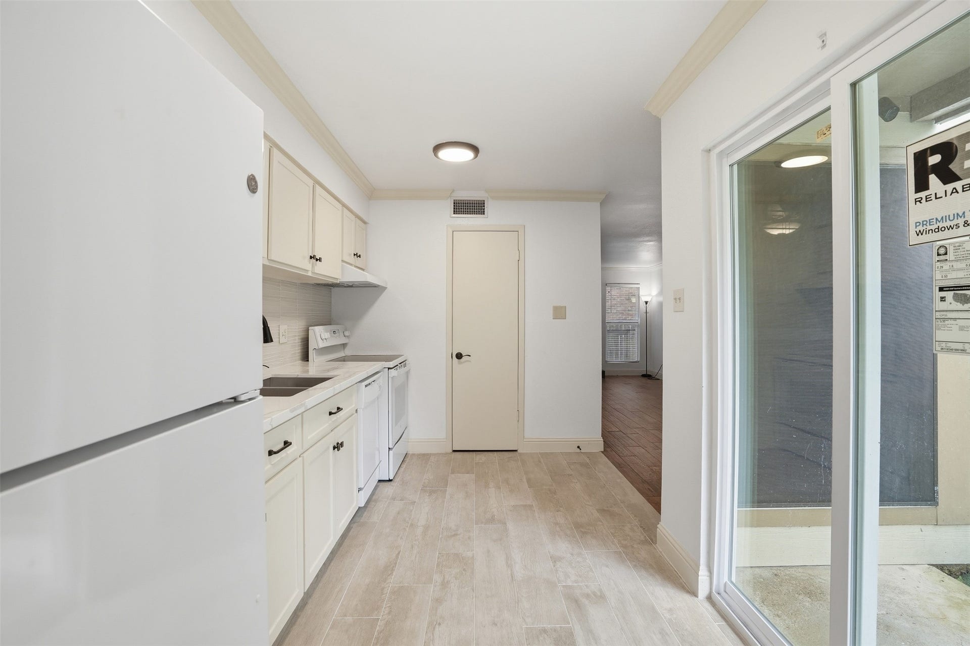 Bright kitchen that is open to the dining area and a sliding glass doors leading to the private fenced in patio.