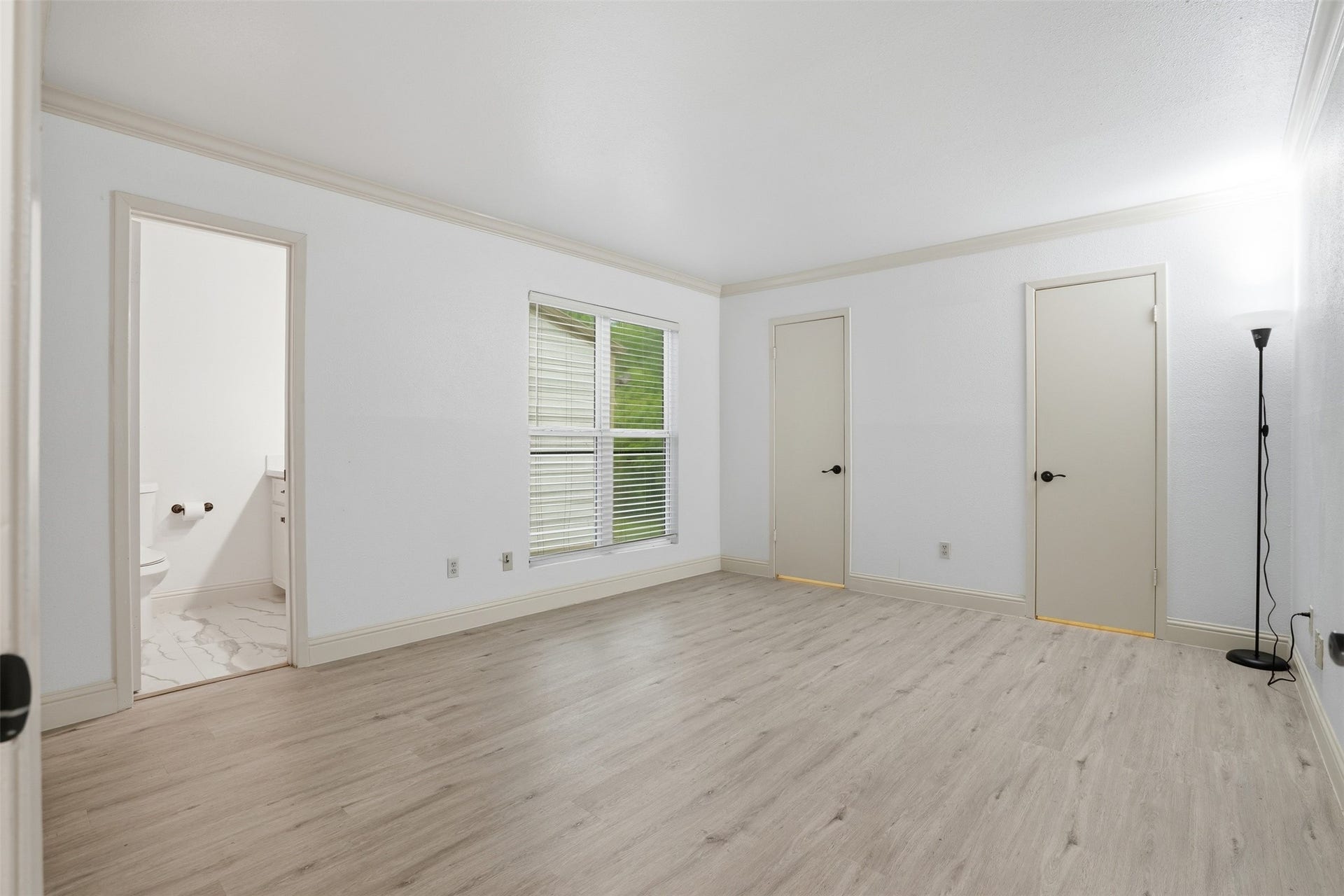 Spacious first Primary, beautiful crown molding throughout! Featuring two walk in closets, an es suit bath and an additional linen closet!