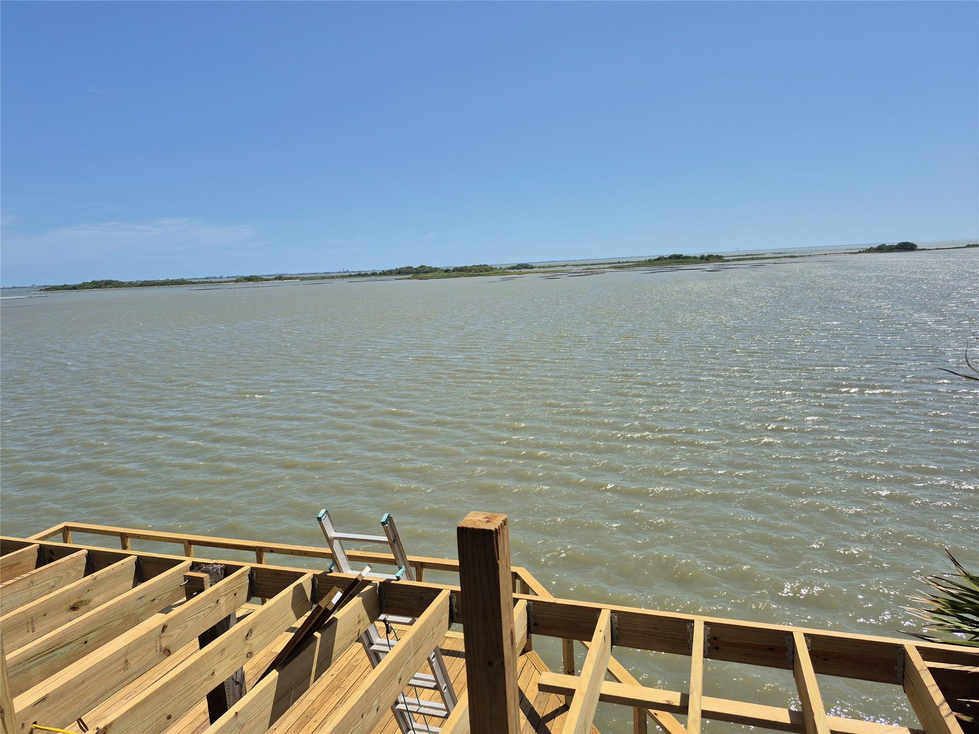 1823 Port O Call Street, Tiki Island, TX 77554 Bayfront all new decks stairs boat house.