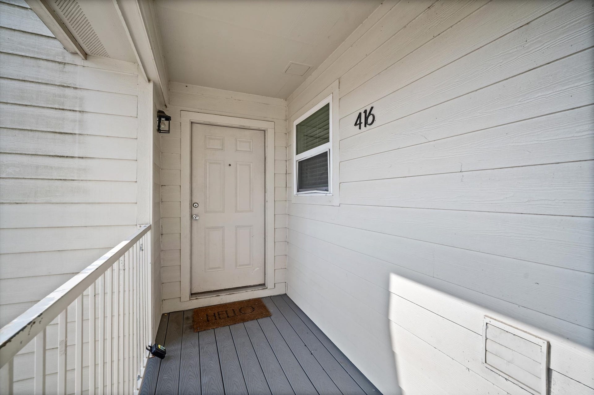 7600 Emmett F Lowry Expressway, #416, Texas City, TX 77591 Charming front entry with a welcoming door and cozy porch area, perfect for greeting guests.