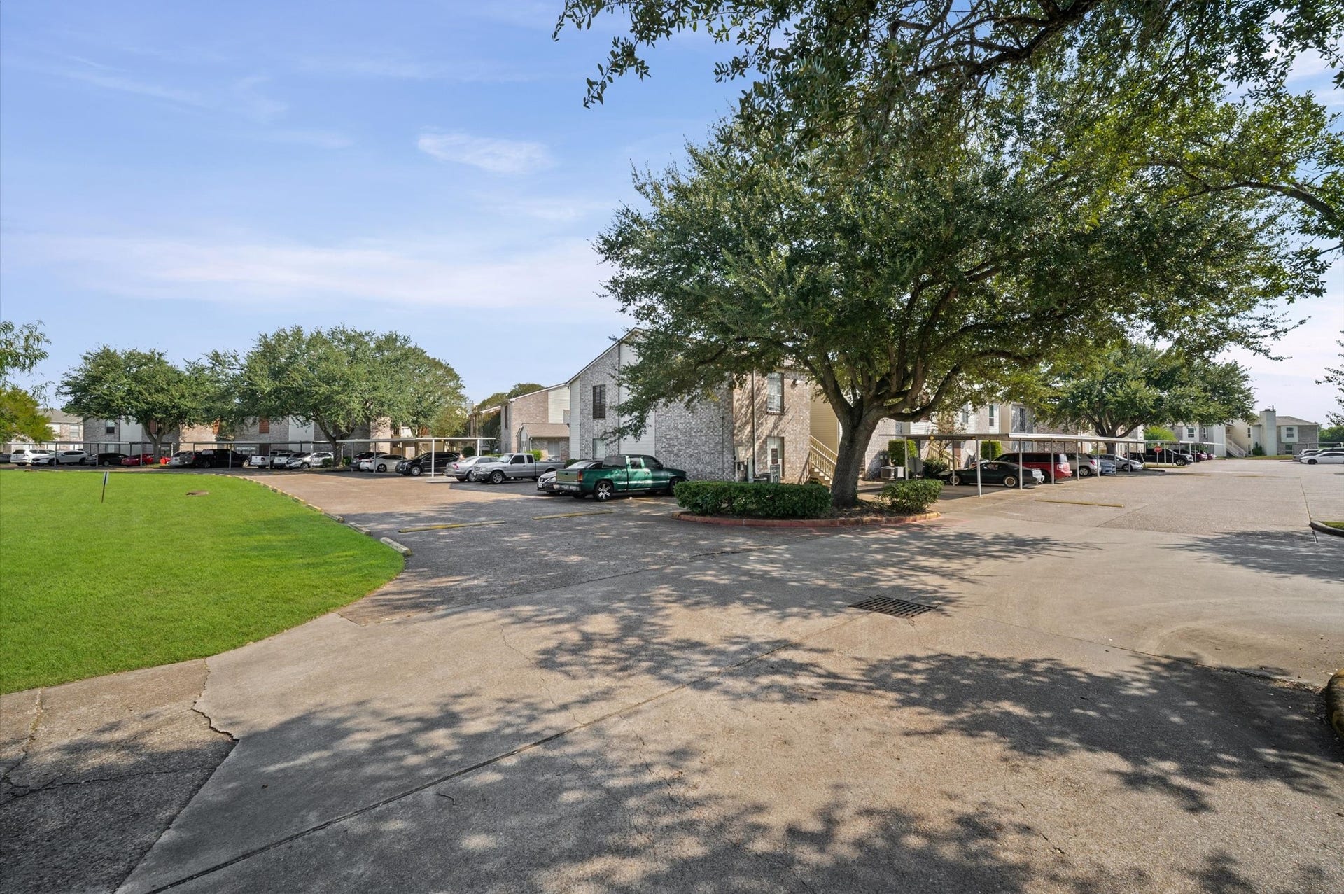 7600 Emmett F Lowry Expressway, #416, Texas City, TX 77591 Charming residential complex with ample parking and lush, mature trees offering shade and tranquility.
