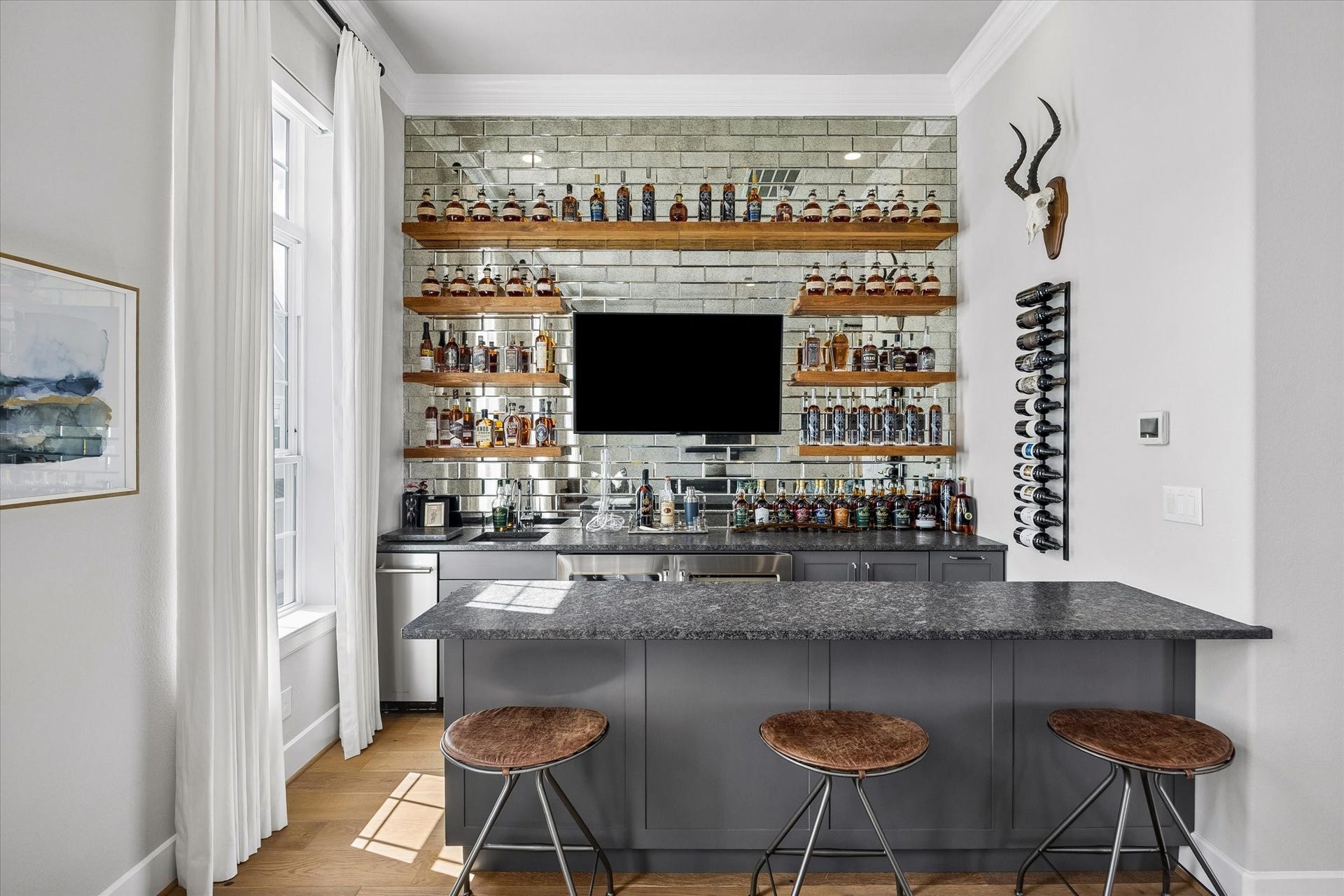 Another perspective of the bar area highlights the meticulous craftsmanship and thoughtful elements integrated into this custom-designed space.