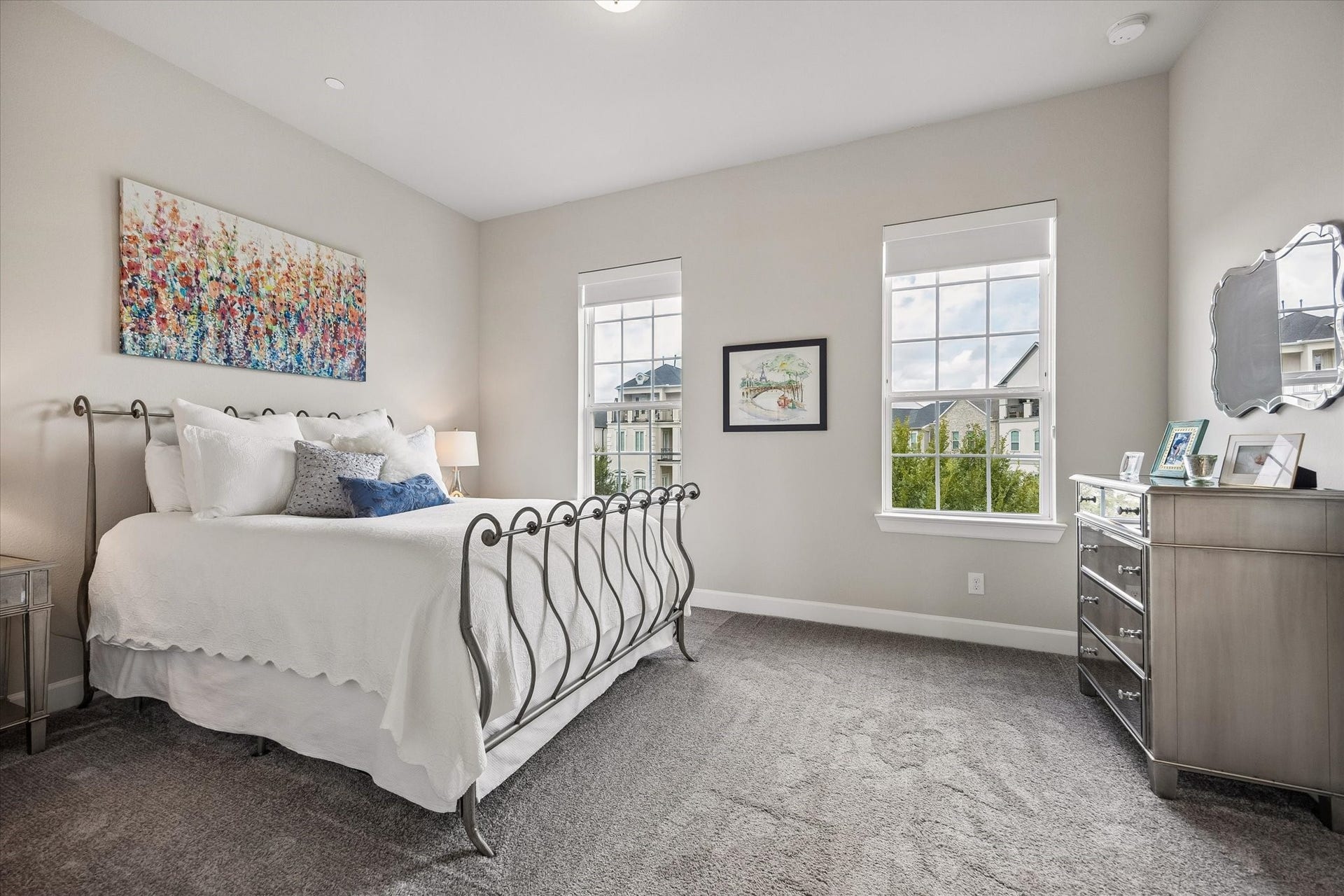 Located on the third floor, this expansive guest bedroom offers a private ensuite bath and a generous walk-in closet. Large windows frame elevated views of the treetops, creating a serene atmosphere.