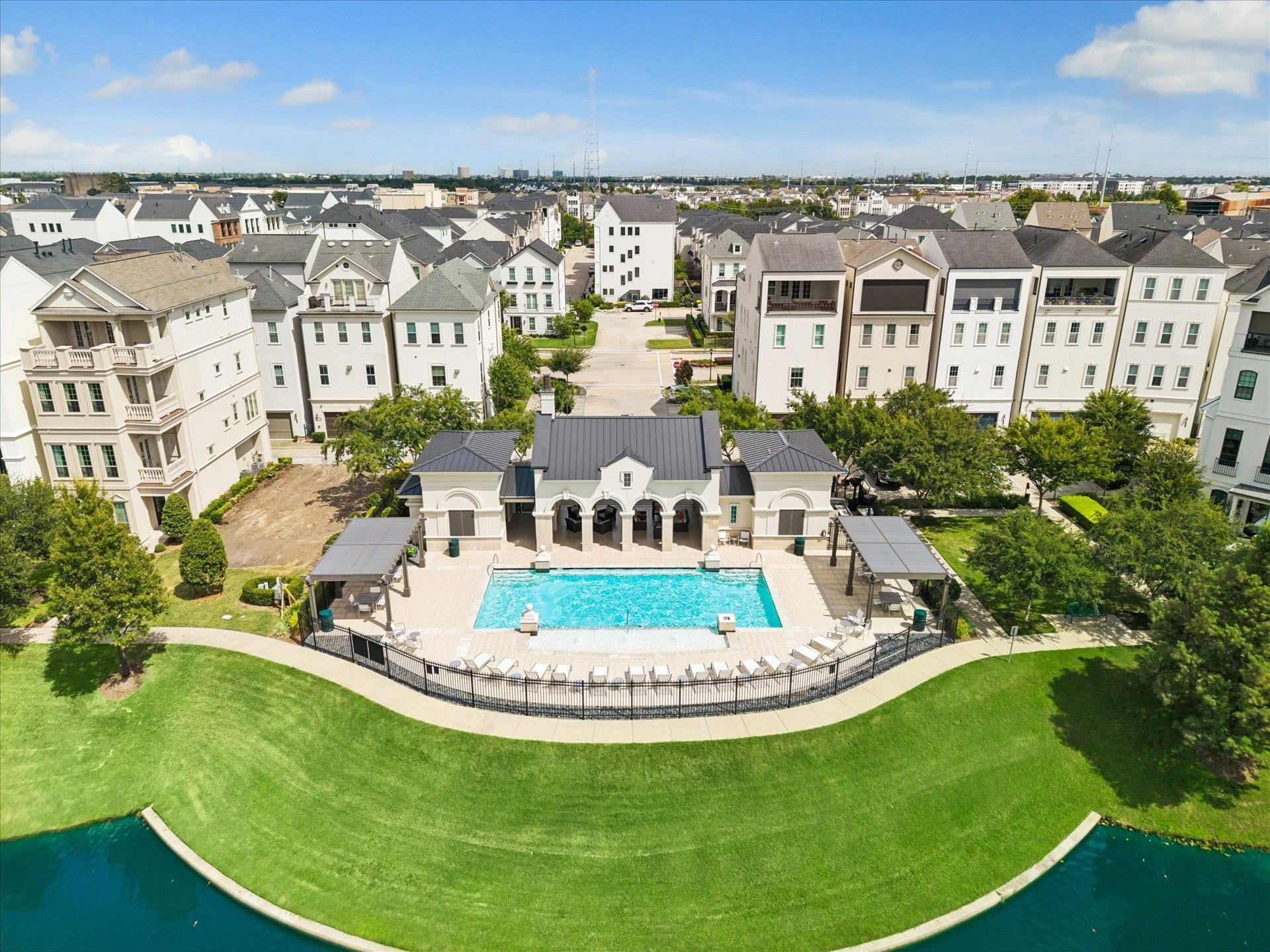 Enjoy a stunning perspective overlooking the community, pool, and lush green spaces. The gated neighborhood provides a scenic lake, which is encircled by peaceful trails for outdoor enjoyment.