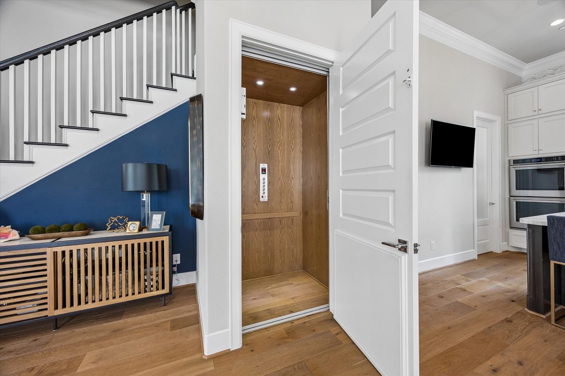 Transition between floors with the beautifully wood-paneled elevator, providing seamless access to every level of the home.