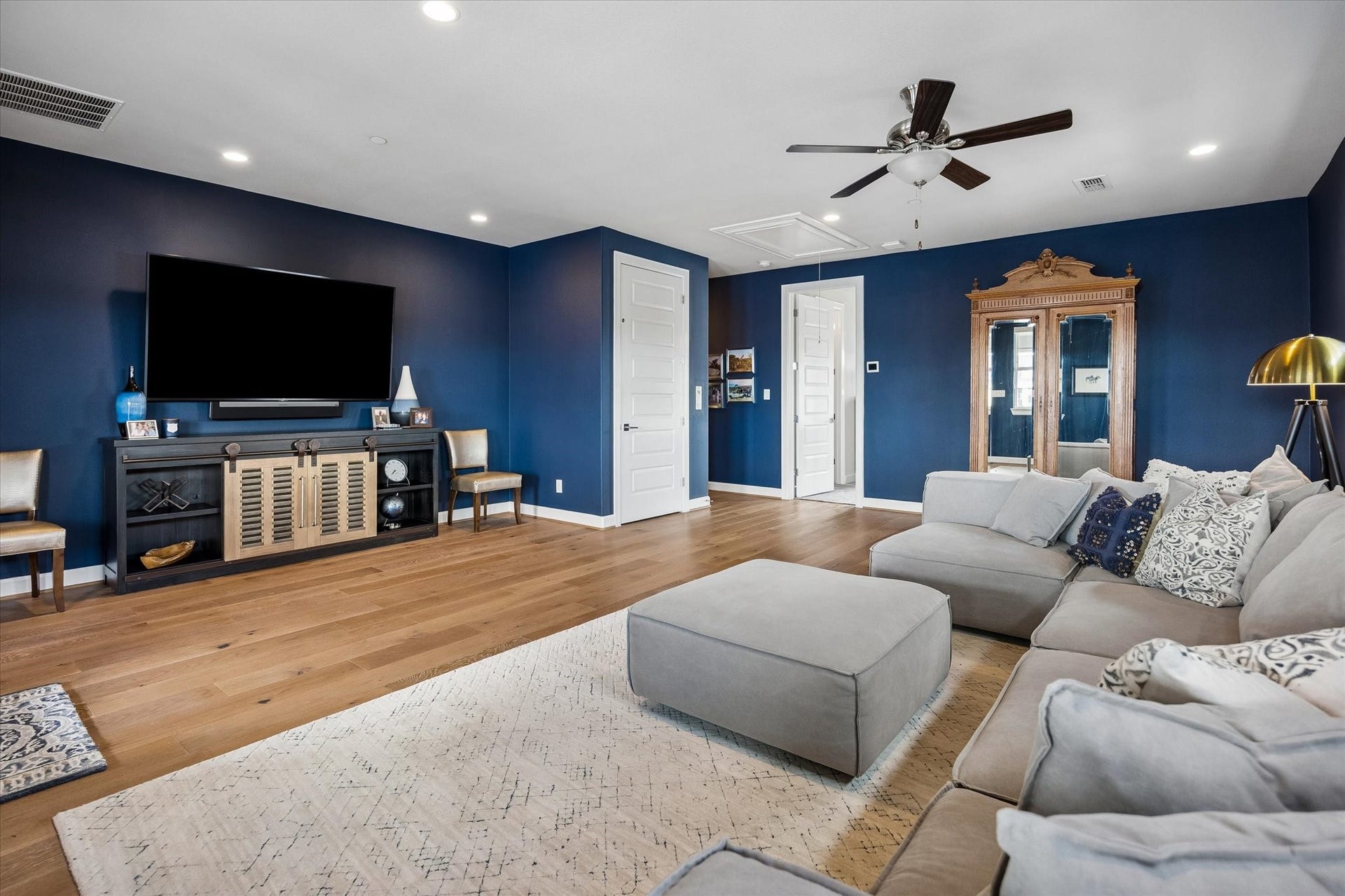This expansive game room flows seamlessly into a private guest bedroom, complete with a well-appointed bathroom that conveniently serves both the entertainment space and the guest bedroom.