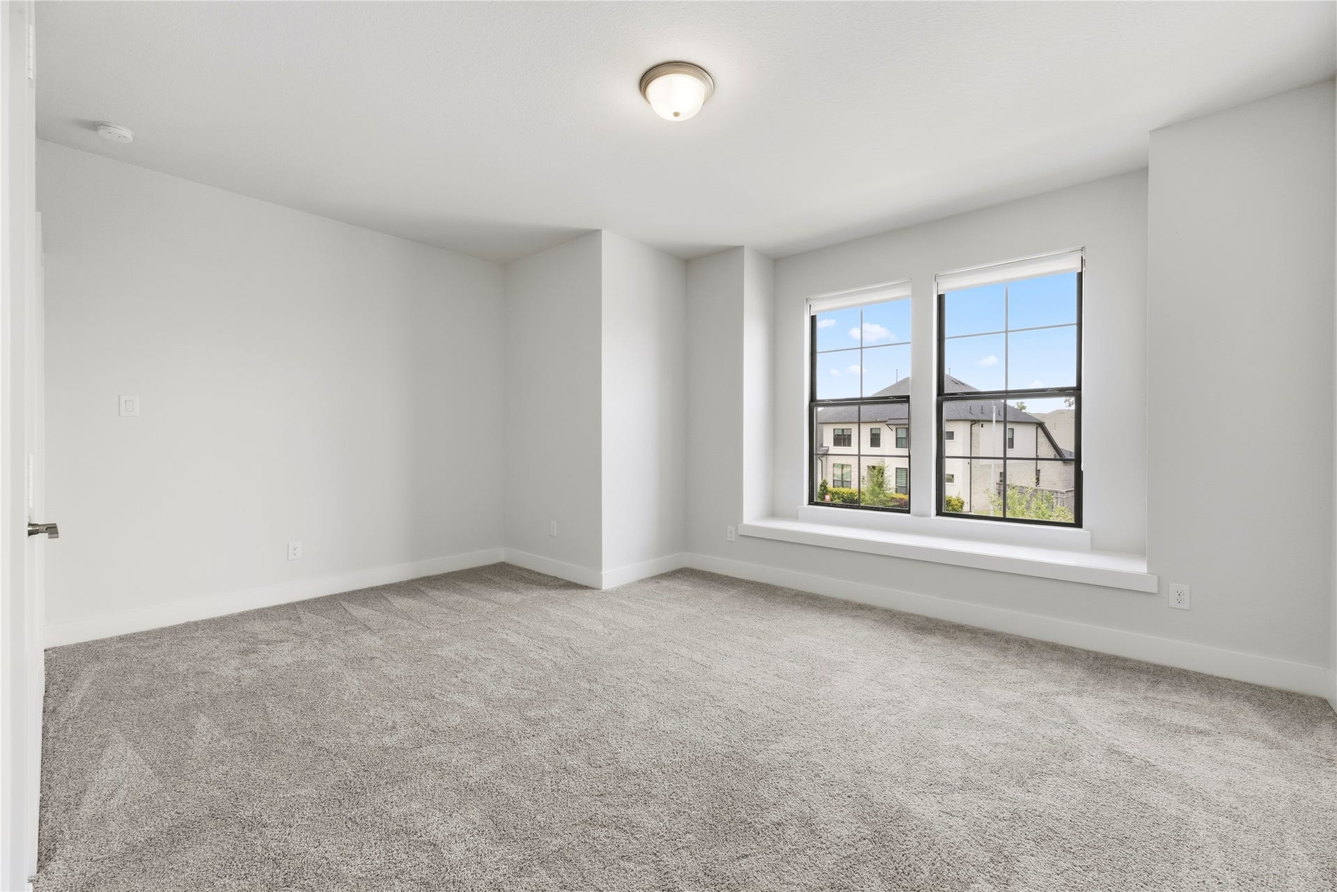 10314 Forest Lake Drive, Missouri City, TX 77459 Spacious secondary bedroom featuring fresh carpet, neutral paint, and double windows with a charming built-in bench seat.
