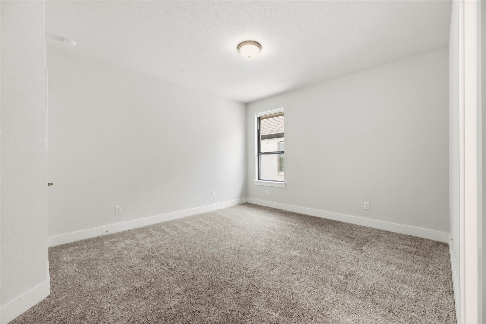 10314 Forest Lake Drive, Missouri City, TX 77459 Move-in ready bedroom featuring neutral walls, soft carpet, and a large window overlooking the side property.