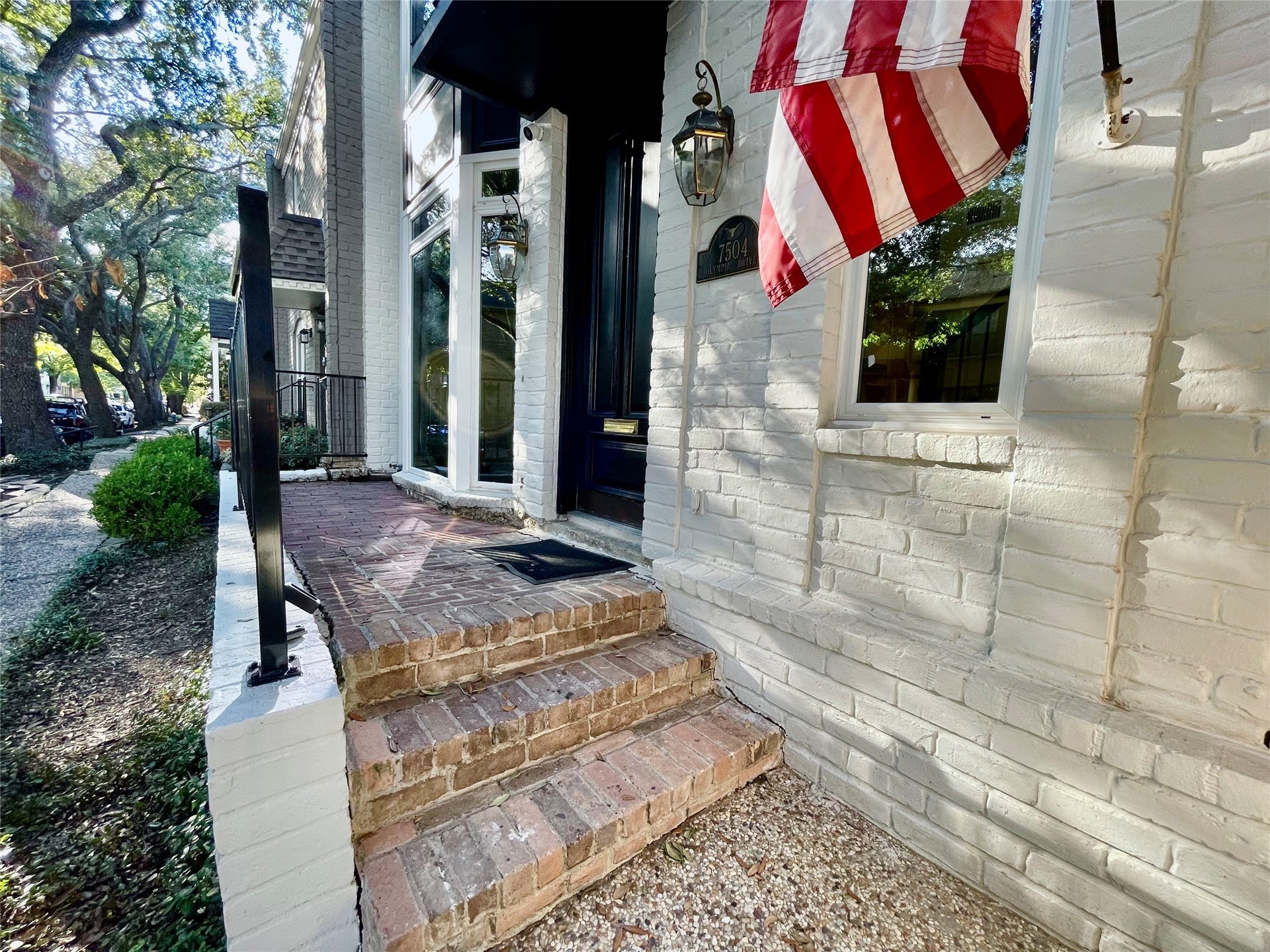 The front entry porch was extended to provide a sitting area or a place for container plants.