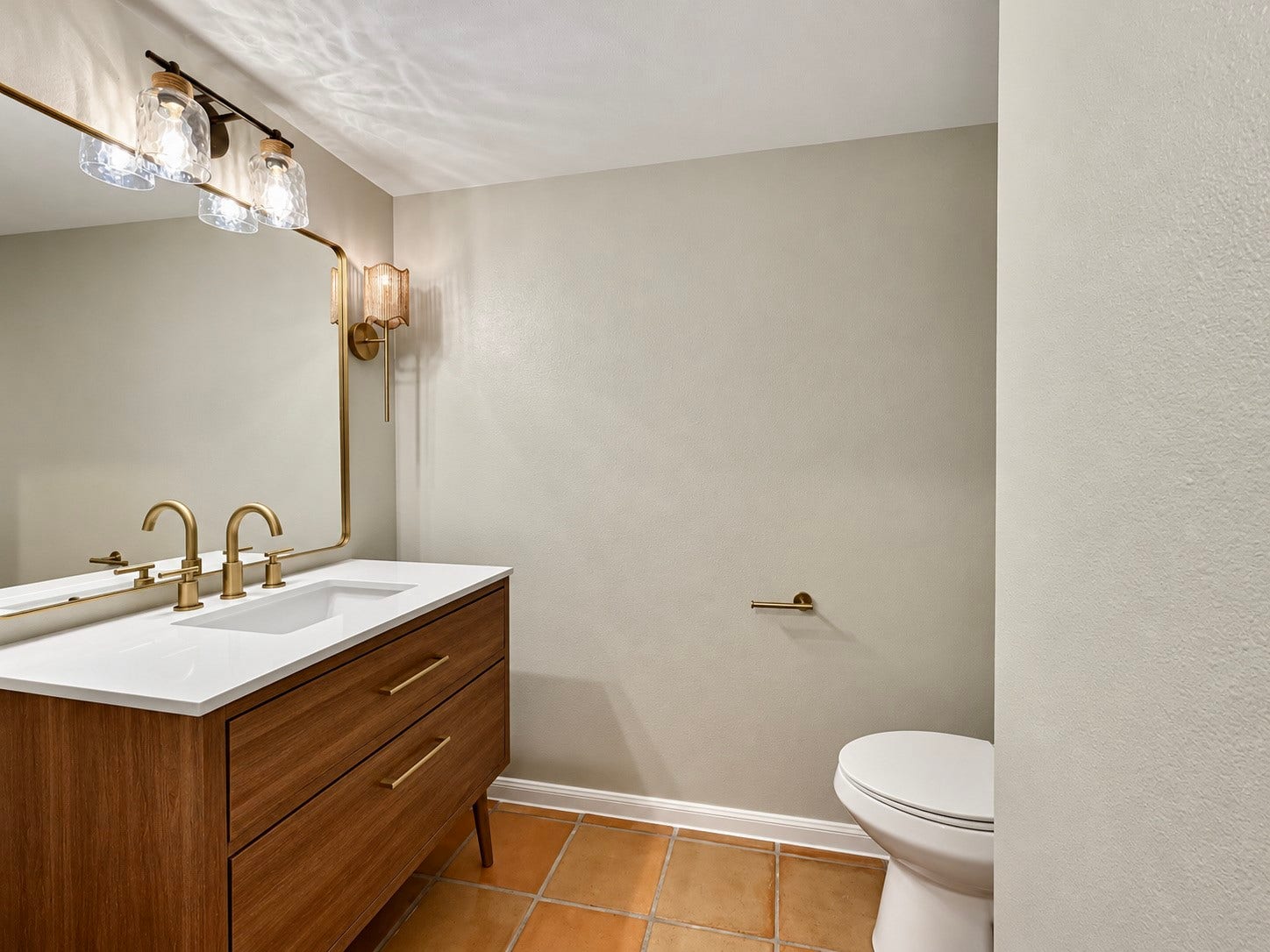 The 1/2 bath received a new vanity, lighting and paint.