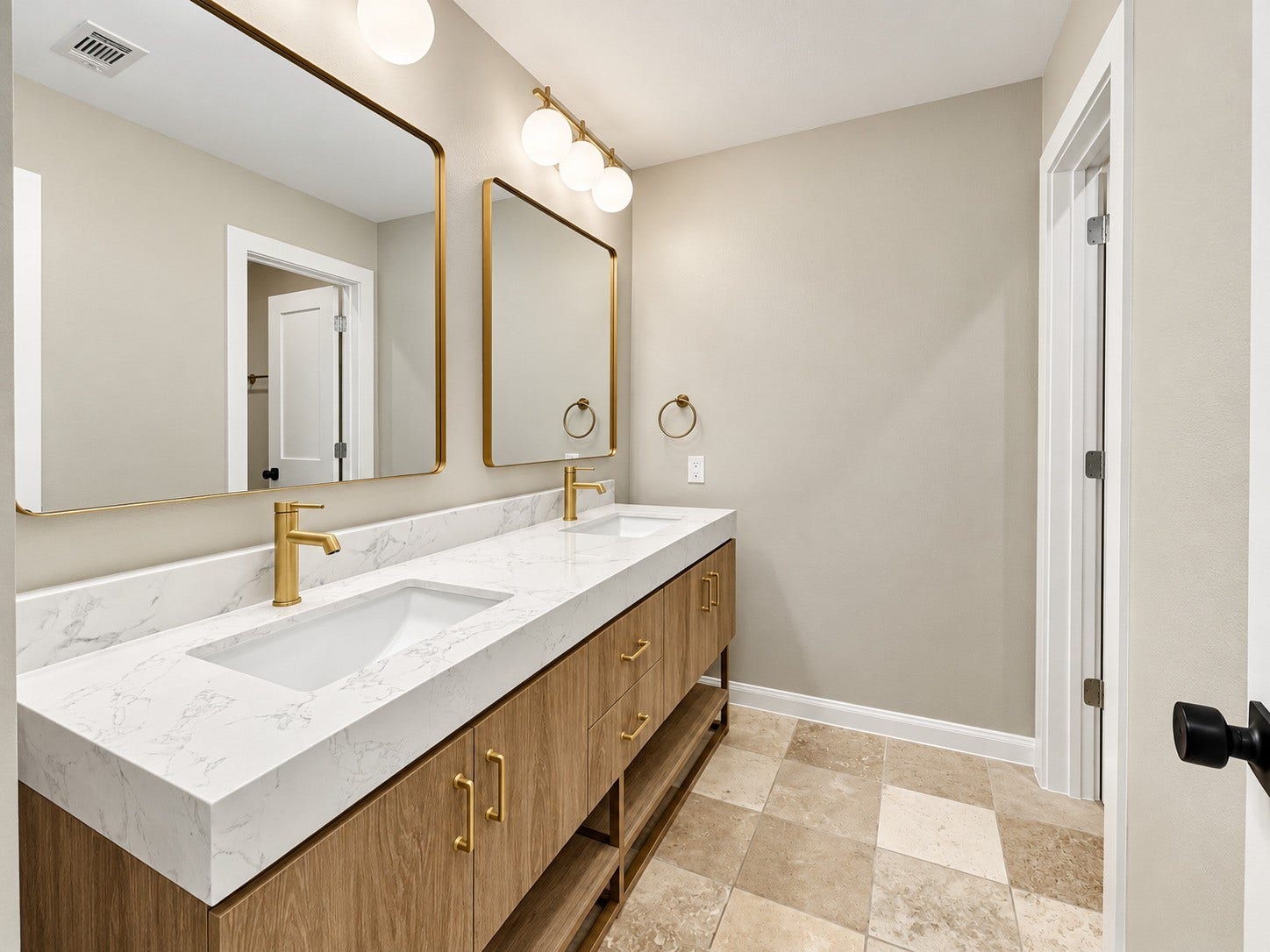 Updated double vanity, paint and lighting give a sophisticated appearance.