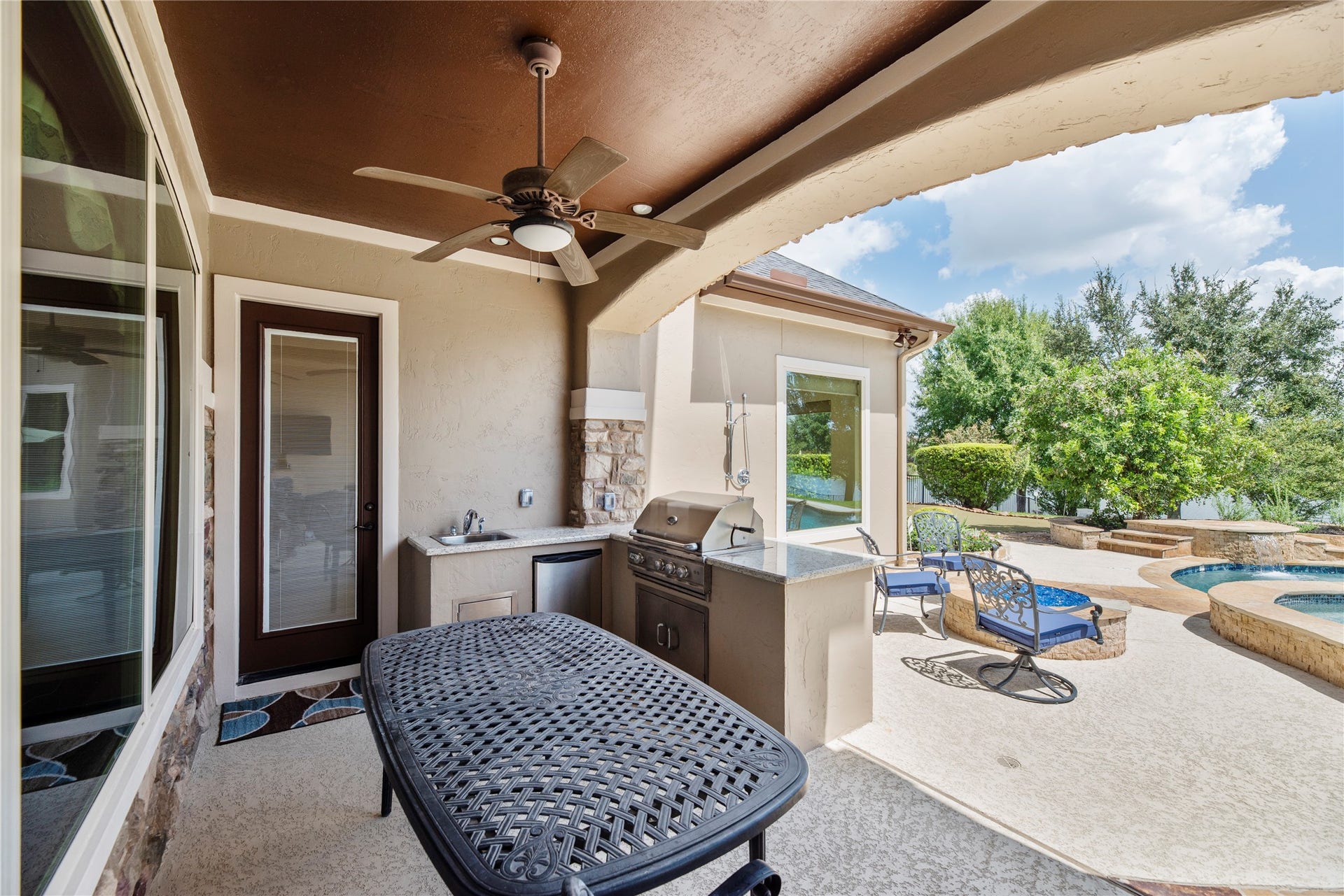 10114 E Frio River Circle N, Cypress, TX 77433 The outdoor kitchen accommodates a table and chairs