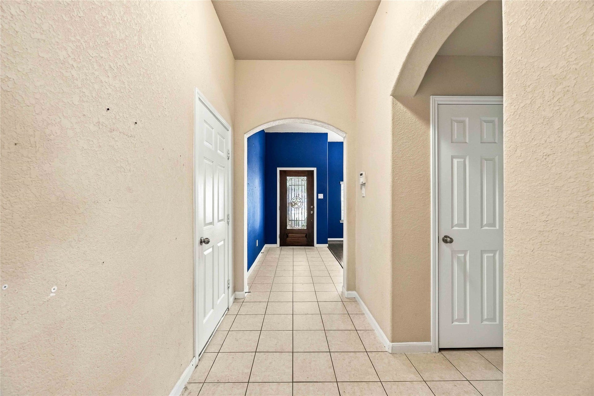 Arched entryway adds character and connects the homes living spaces.