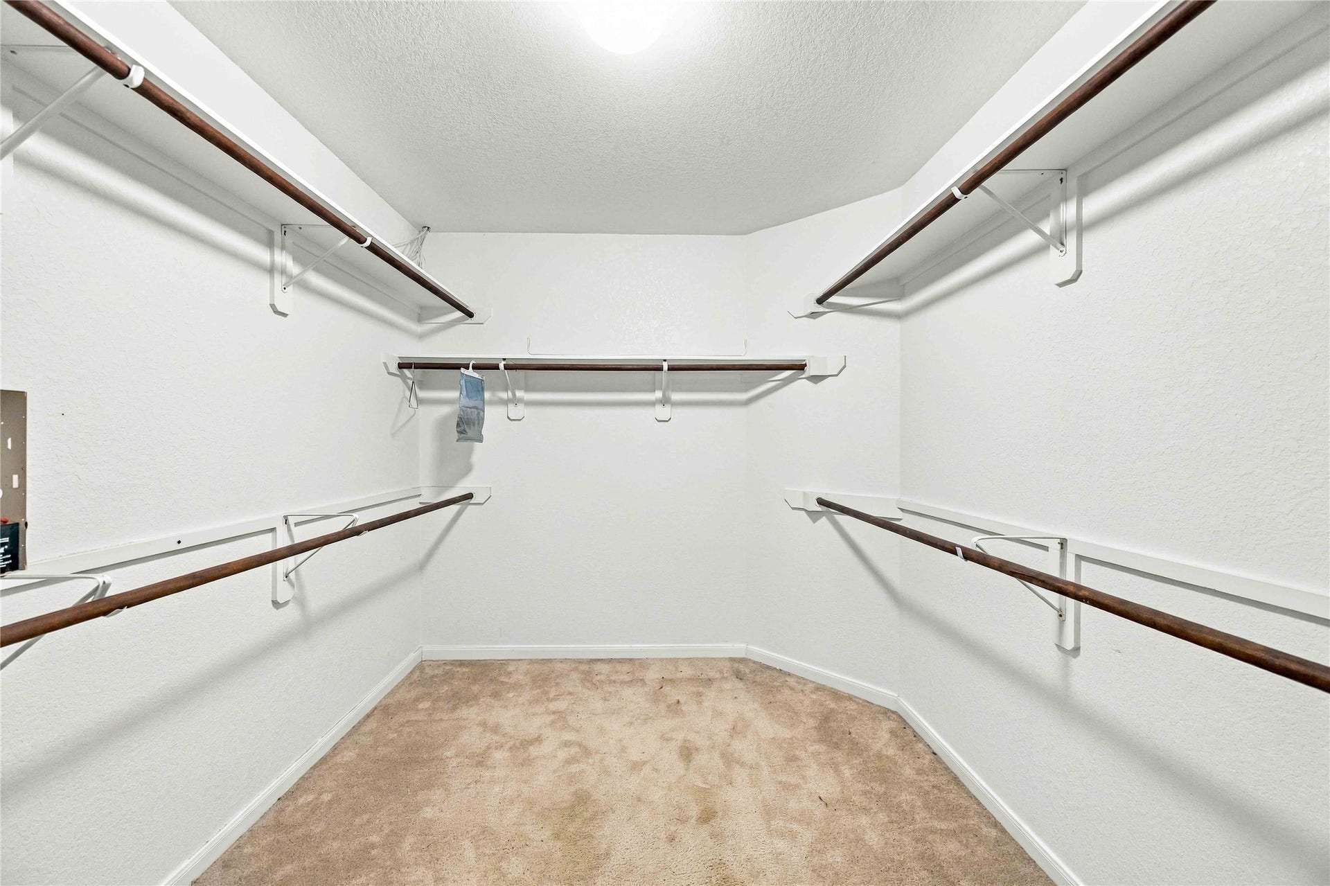 Large walk-in closet offers generous shelving and hanging space.
