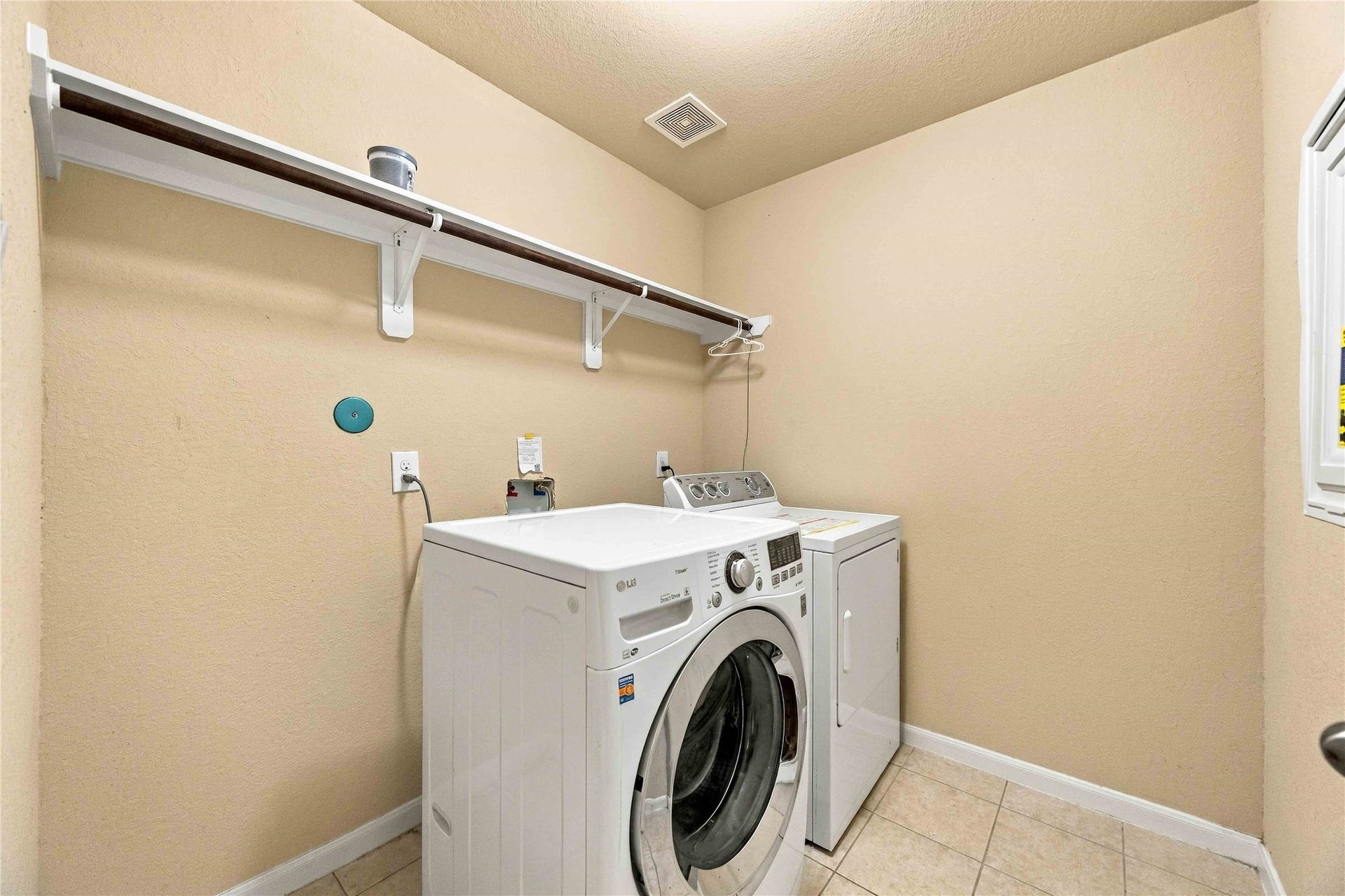 Dedicated utility room with built-in shelving for added storage.