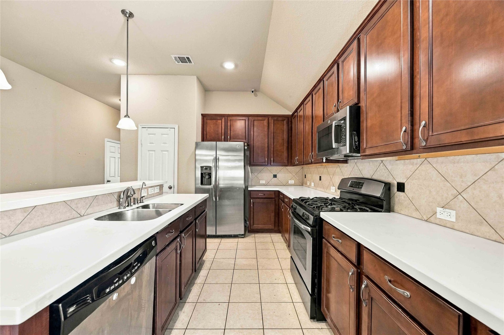 Stainless steel appliances complement the spacious kitchen.