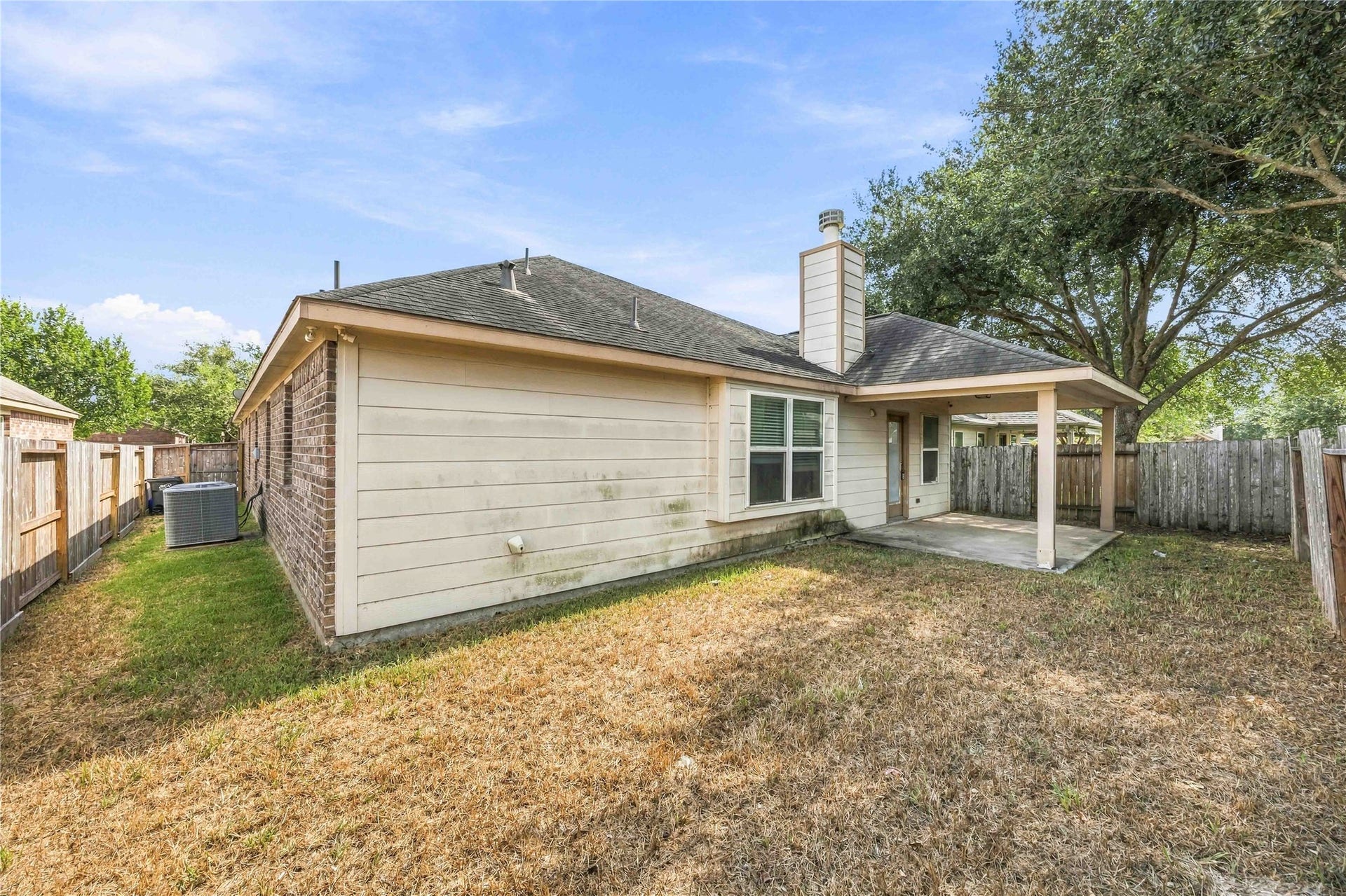 Spacious backyard with covered patio and room to make the space your own.