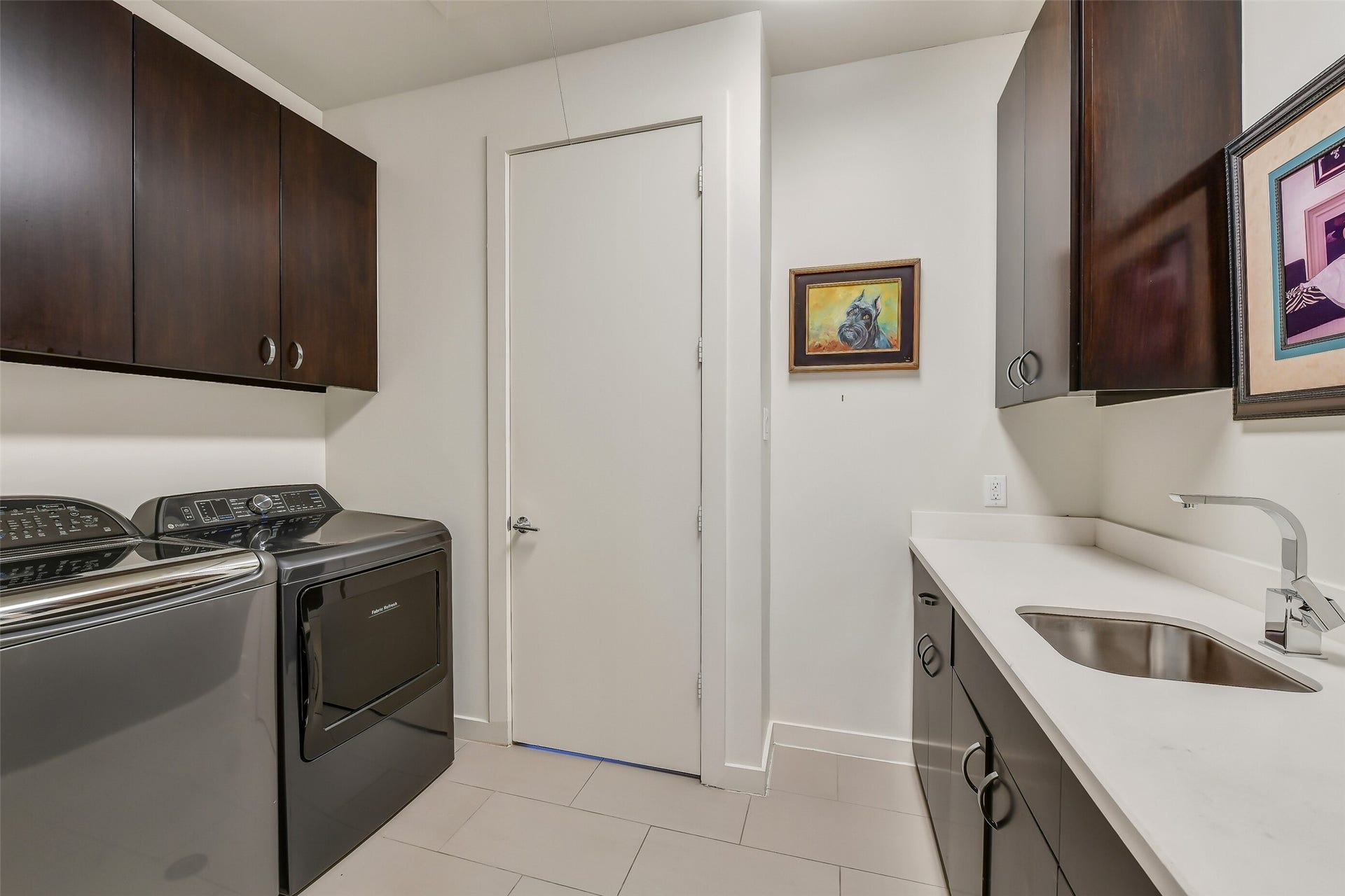 2302 Persa Street, Houston, TX 77019 This photo showcases a well-appointed laundry room designed with convenience, efficiency, and contemporary style in mind.