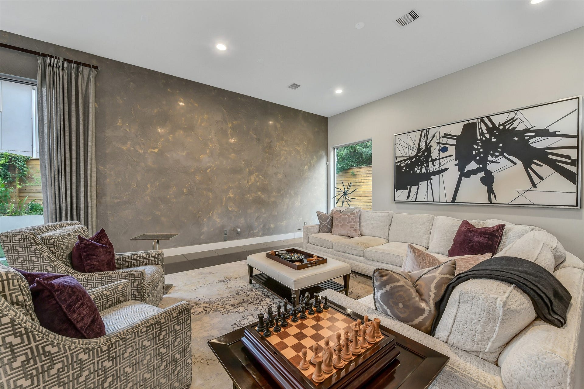 2302 Persa Street, Houston, TX 77019 With recessed lighting and dramatic faux-finish plastered wall, this light-filled living area offers an elegant setting for relaxing and entertaining.