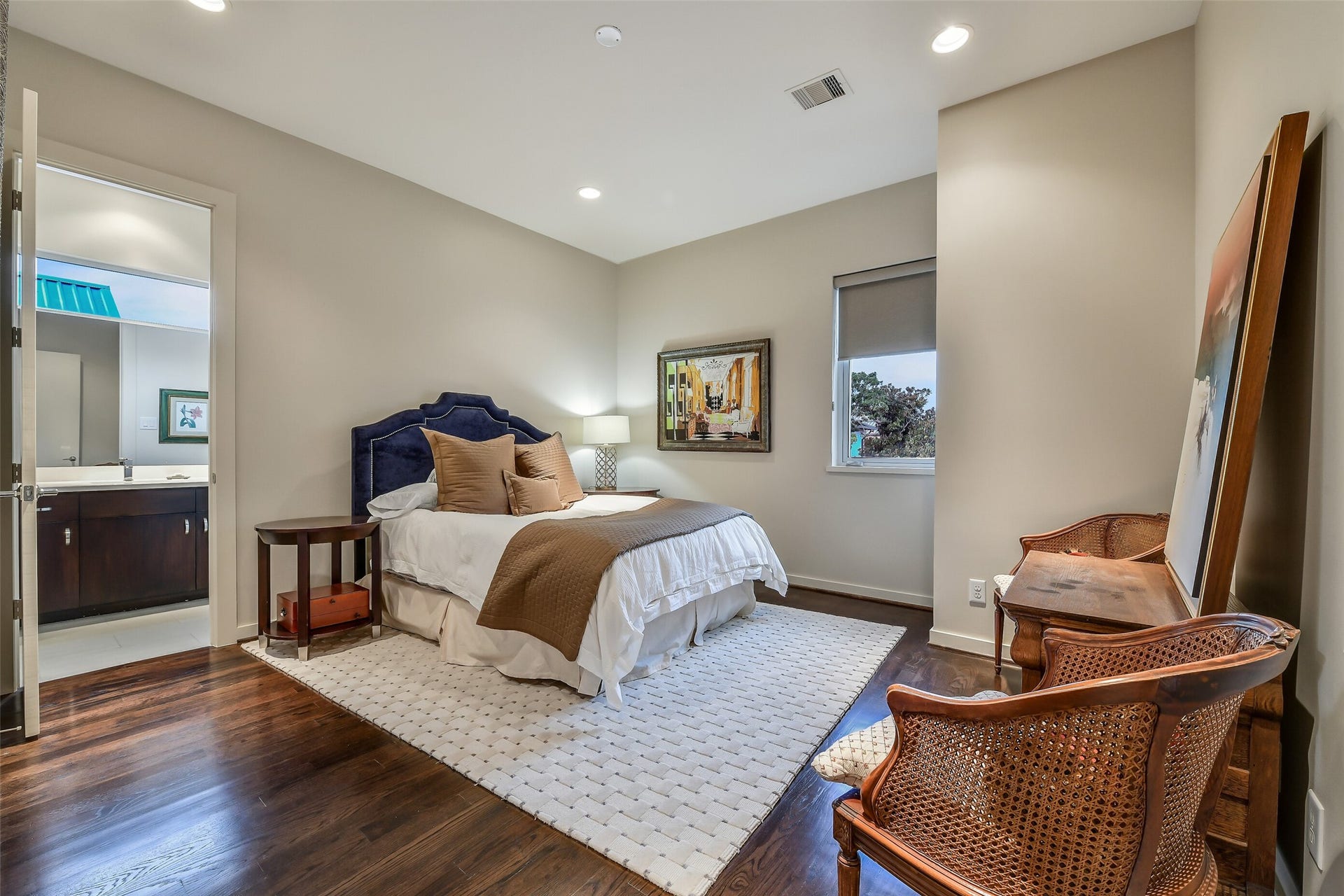 2302 Persa Street, Houston, TX 77019 This light-filled secondary bedroom features rich dark hardwood floors, crisp neutral walls, and comfortable proportions.