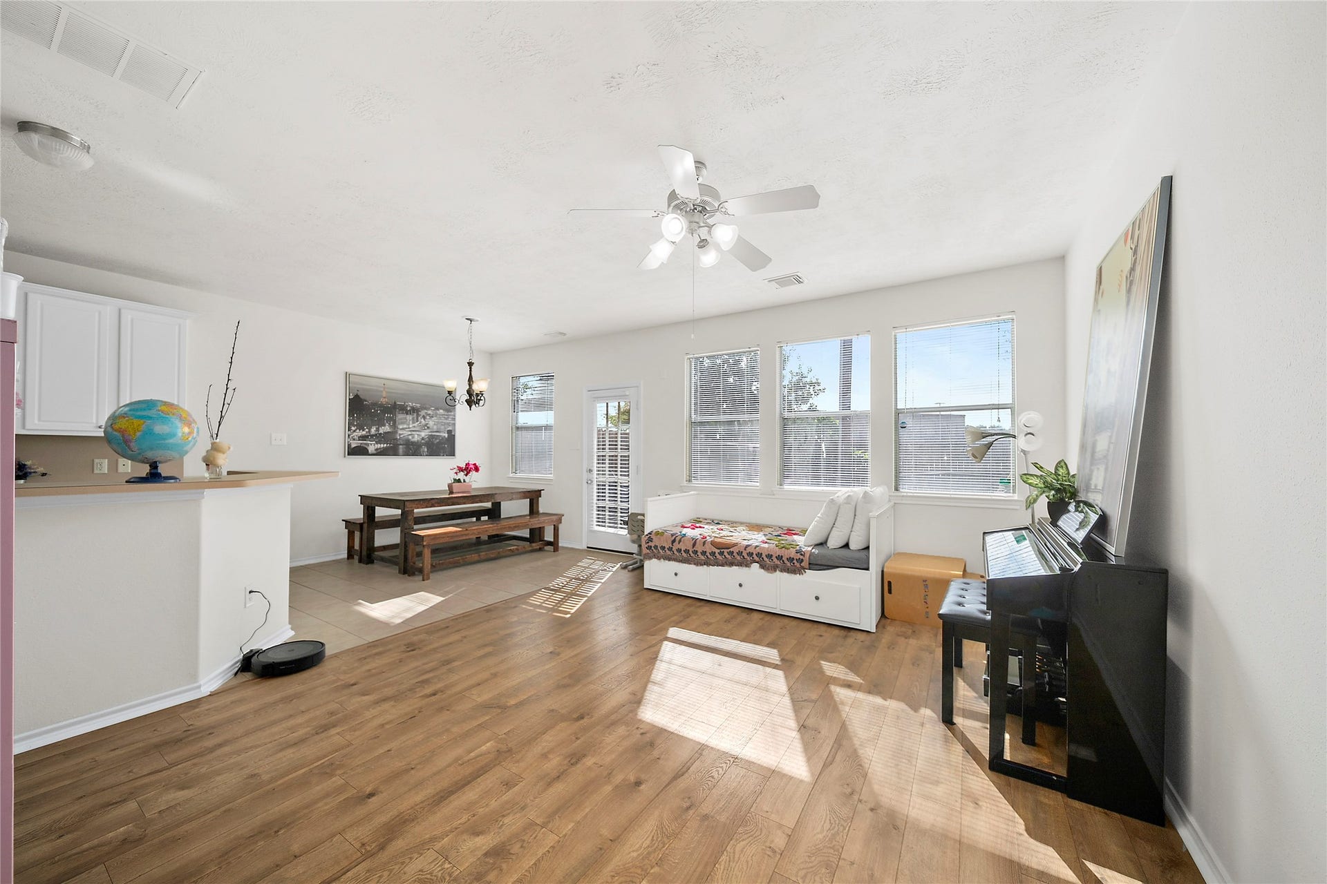 This bright and airy living space features abundant natural light, elegant wood flooring, and a seamless flow to the dining area. Perfect for relaxation and entertaining.