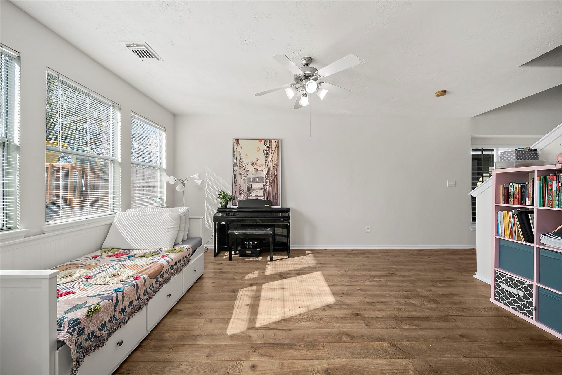Flooded with natural light, this inviting space features elegant wood floors and a cozy reading nook. Perfect for relaxation and creativity.