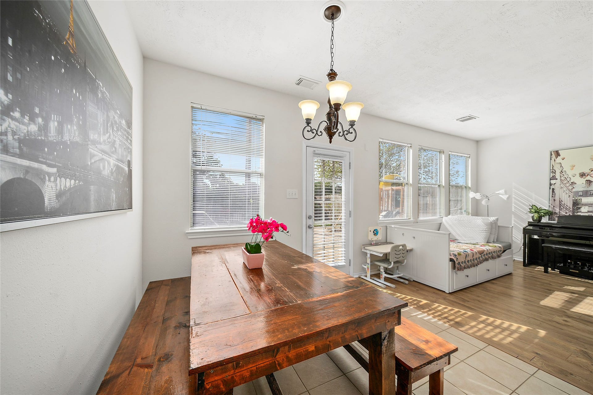 Bright and inviting dining area featuring ample natural light, elegant chandelier, and seamless access to the outdoor space. Perfect for entertaining or cozy family meals.