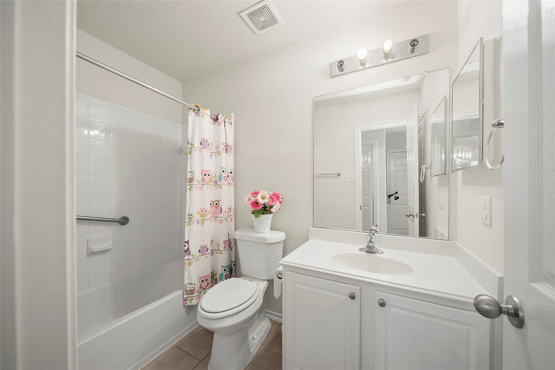 Bright and inviting secondary bathroom featuring a full bathtub, sleek vanity, and ample storage. Perfect for guests or family use.