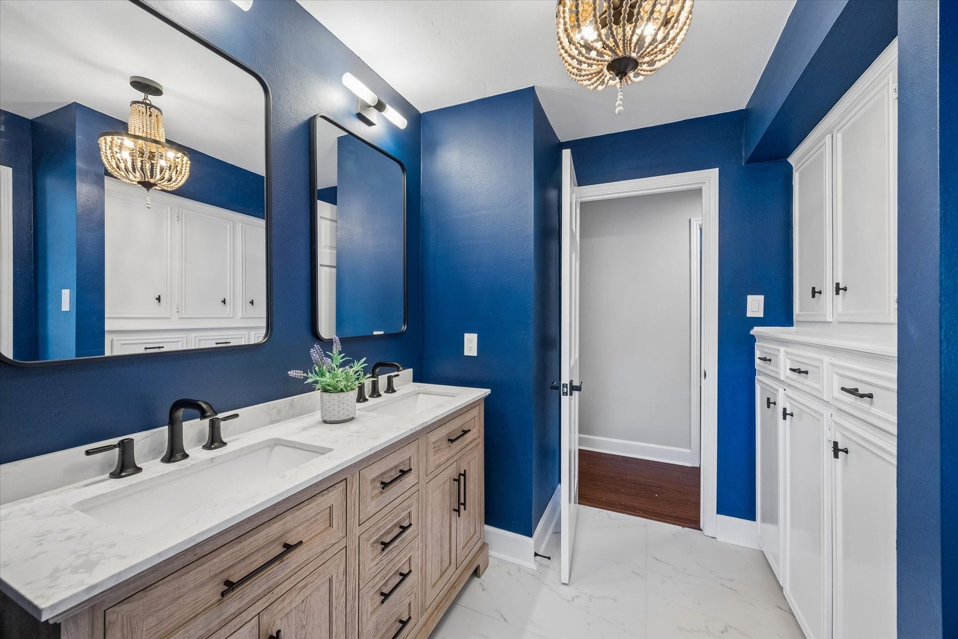 7827 Zilonis Court, Jersey Village, TX 77040 Elegant upstairs bathroom featuring wood chandelier and convenient built-ins for ample storage.