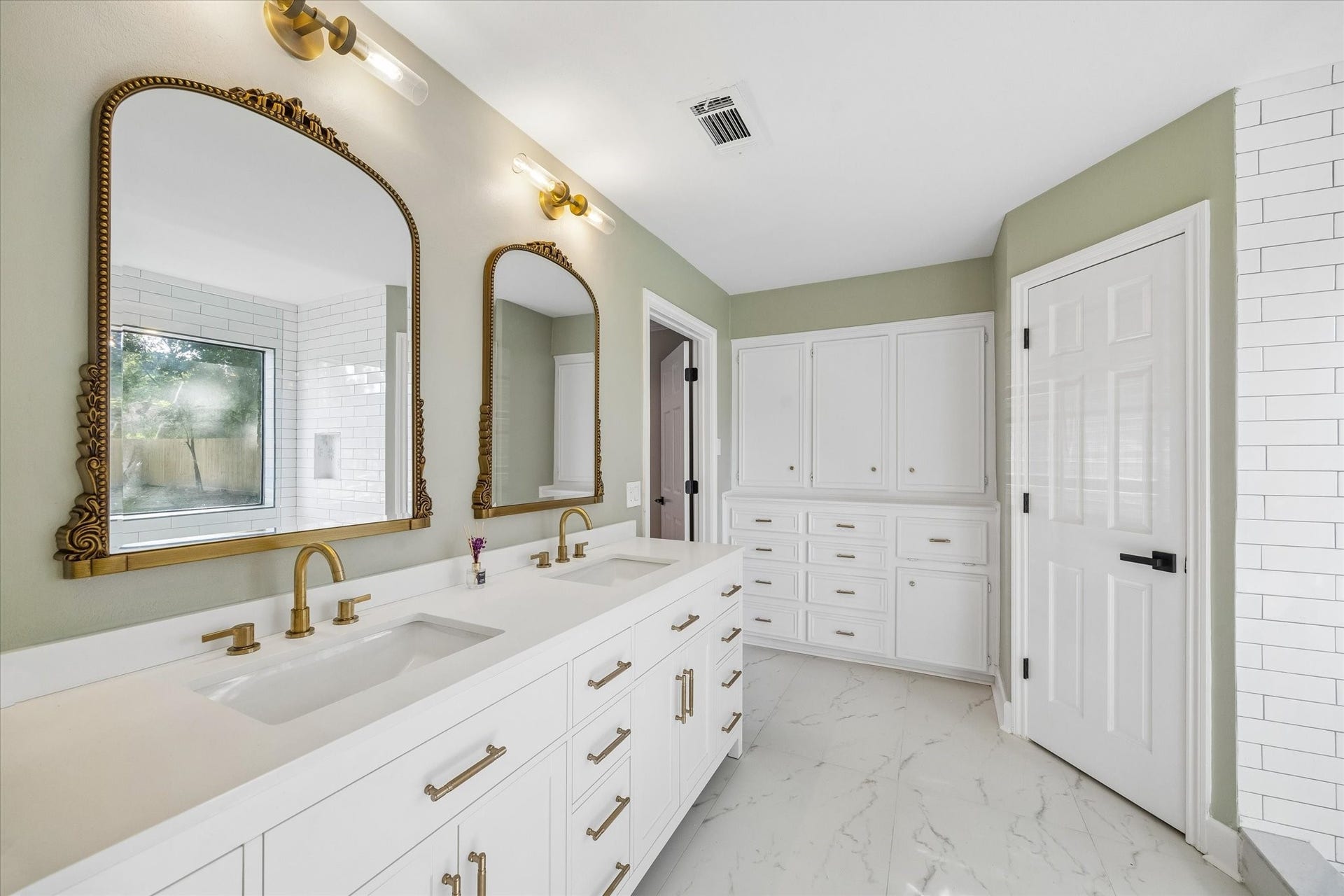 7827 Zilonis Court, Jersey Village, TX 77040 Elegant double sink vanity with a granite top, gold handles & mirrors, new faucets and ample storage.