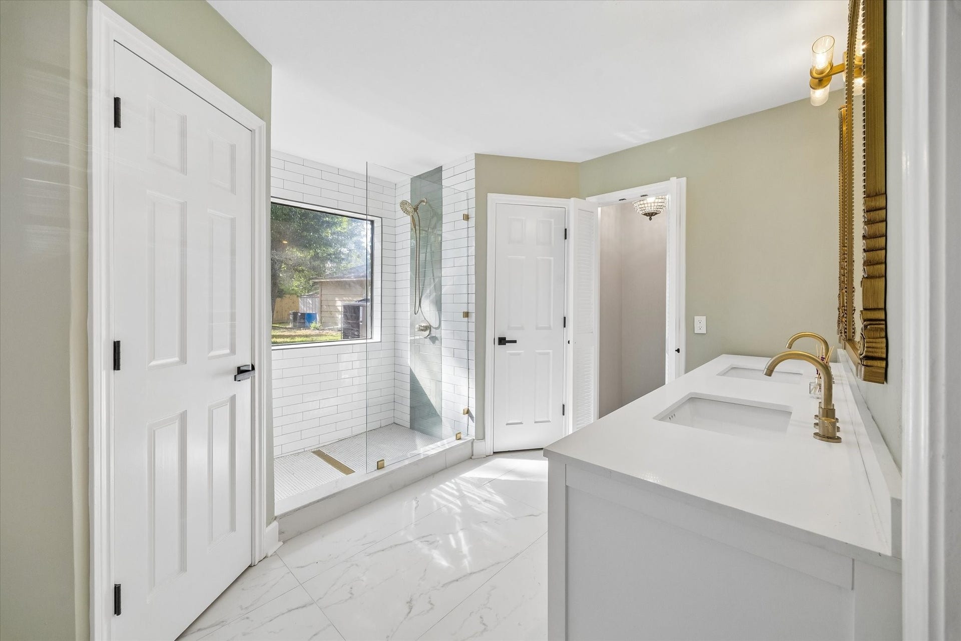 7827 Zilonis Court, Jersey Village, TX 77040 Luxurious master bathroom featuring a sleek glass-enclosed shower, dual sinks with elegant fixtures, and ample natural light for a serene retreat.