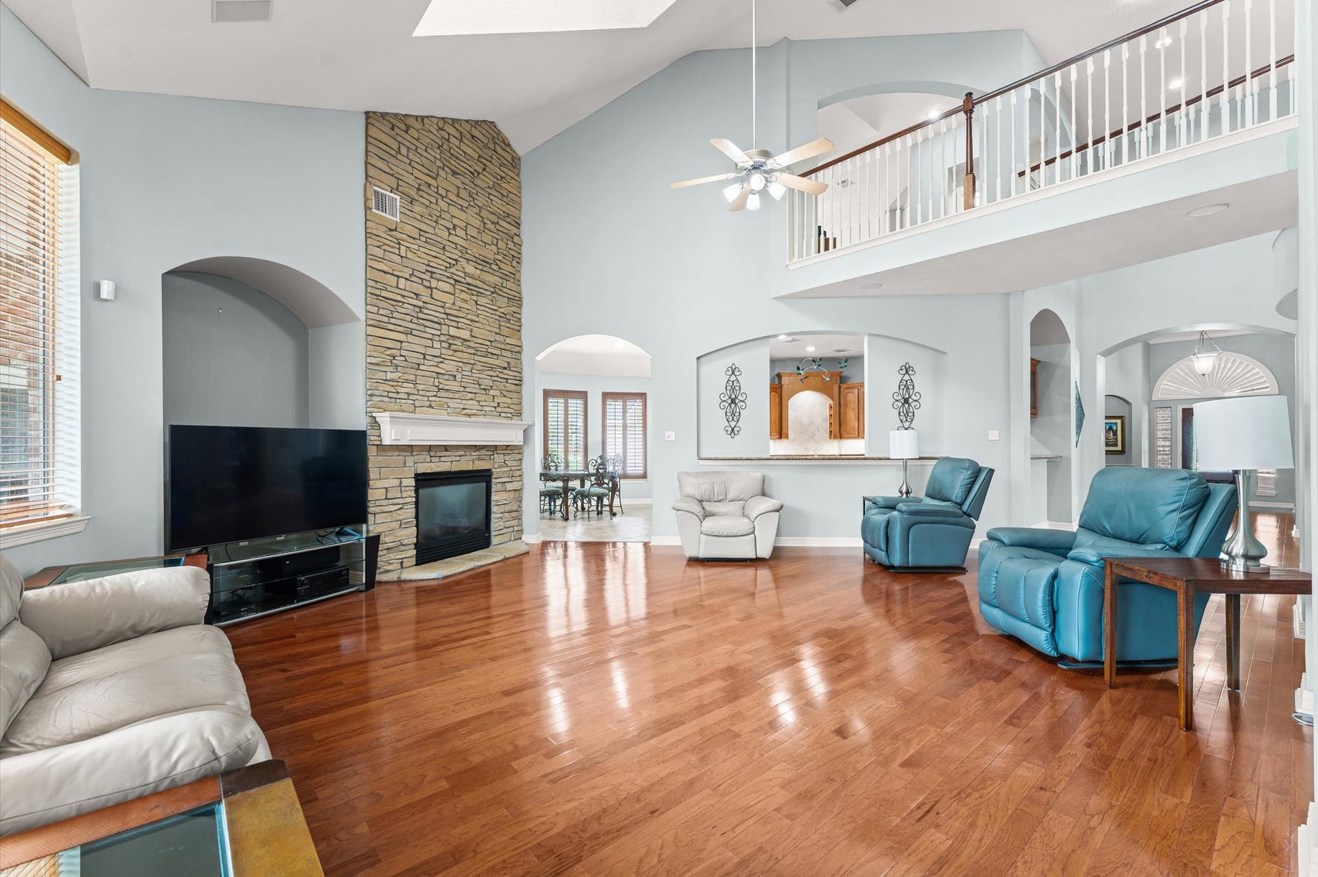 17202 Ledgefield, Cypress, TX 77433 Floor-to-stone ceiling fireplace, tall ceilings, & a nice overlook from the 2nd floor.
