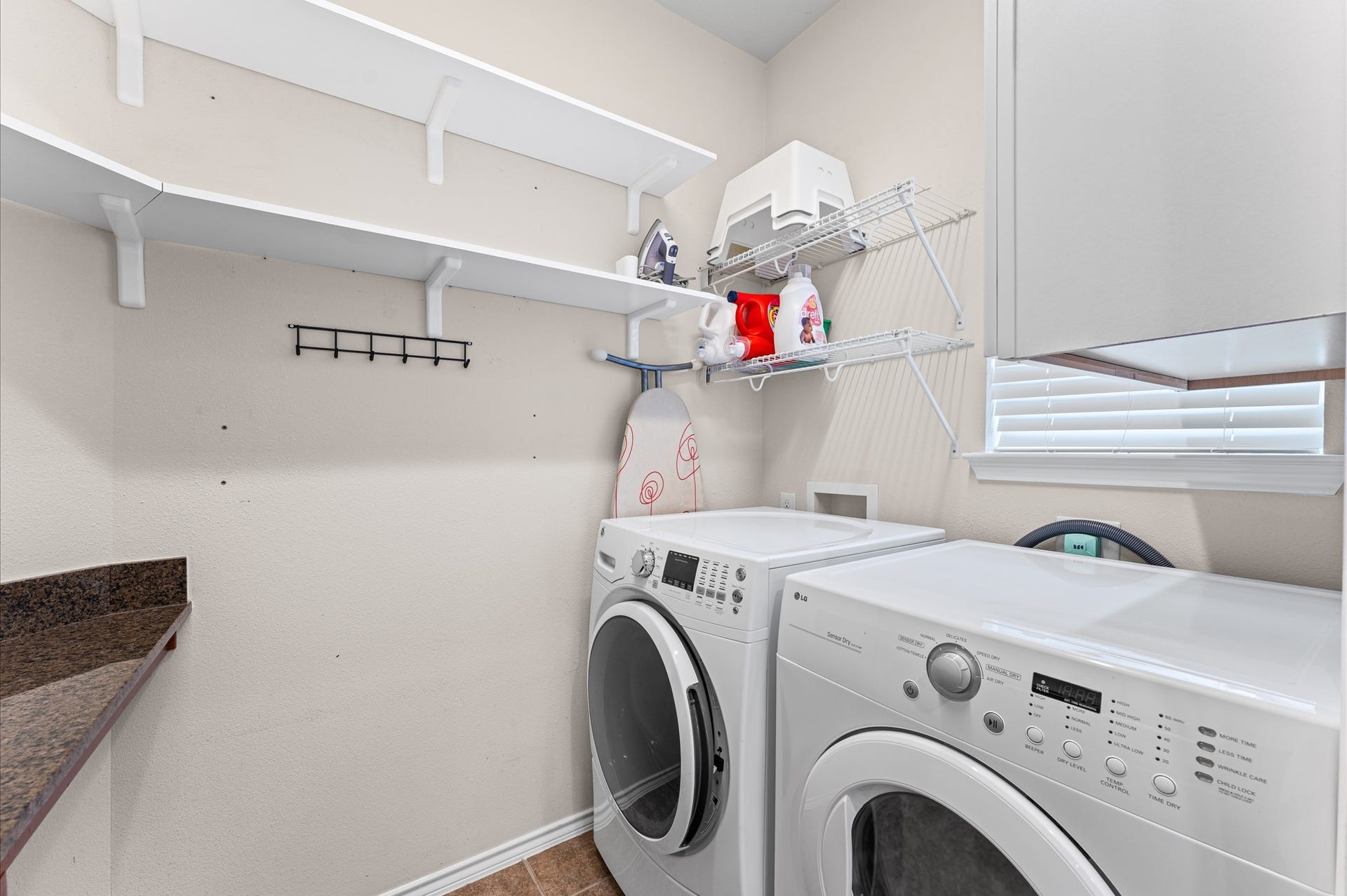 13423 Hartland Lake Lane, Houston, TX 77044 Spacious laundry room with ample shelving for storage, and a convenient countertop workspace.