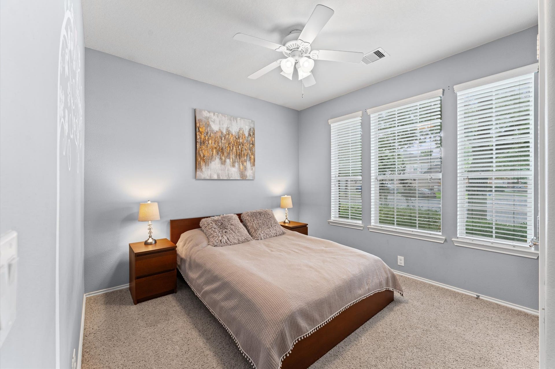 13423 Hartland Lake Lane, Houston, TX 77044 Bright and inviting bedroom with neutral walls, featuring large windows that let in plenty of natural light.