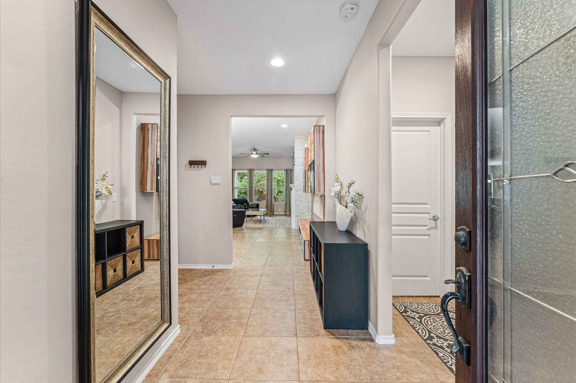 13423 Hartland Lake Lane, Houston, TX 77044 Inviting entryway with stylish tile flooring, leading to a bright, open living area.