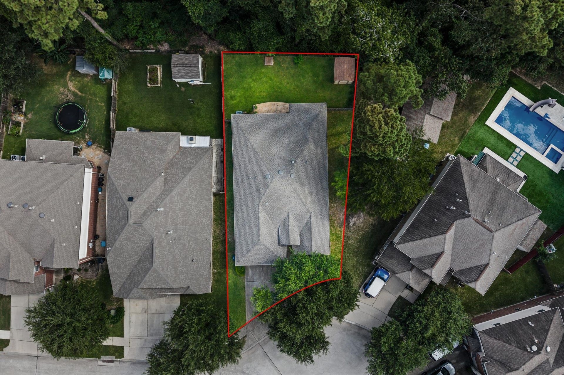 13423 Hartland Lake Lane, Houston, TX 77044 Charming home nestled on a spacious lot with lush greenery, offering a private backyard perfect for outdoor activities and relaxation.