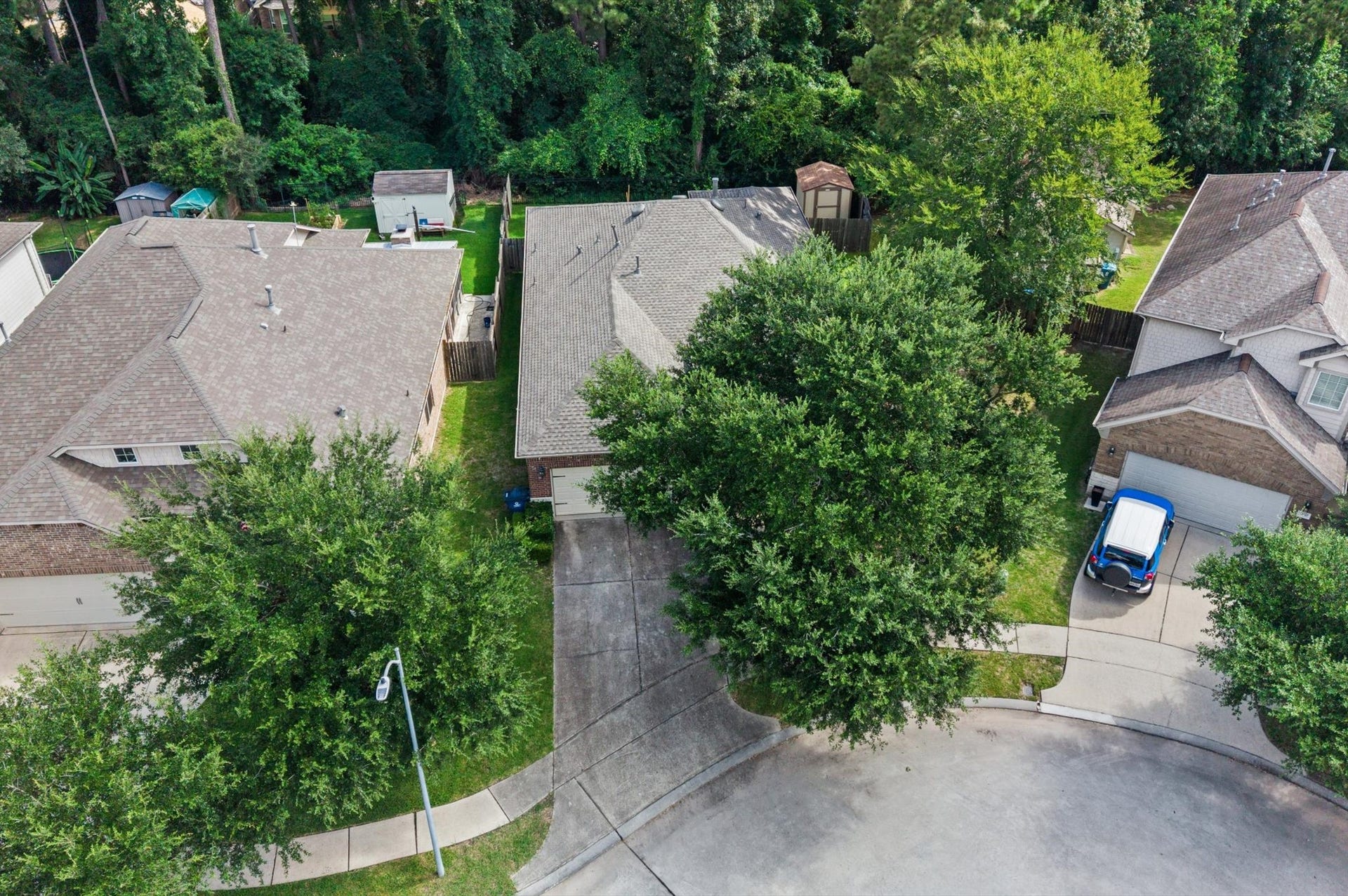 13423 Hartland Lake Lane, Houston, TX 77044 Charming cul-de-sac home nestled among lush greenery, offering privacy and a serene backyard retreat.