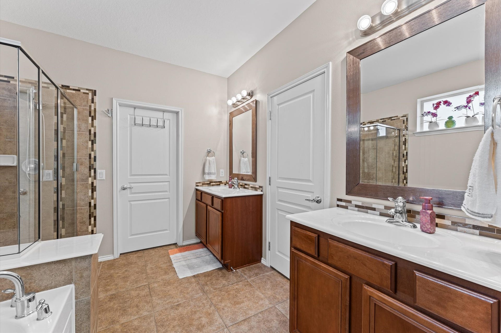 13423 Hartland Lake Lane, Houston, TX 77044 Spacious bathroom featuring dual sinks a glass-enclosed shower.