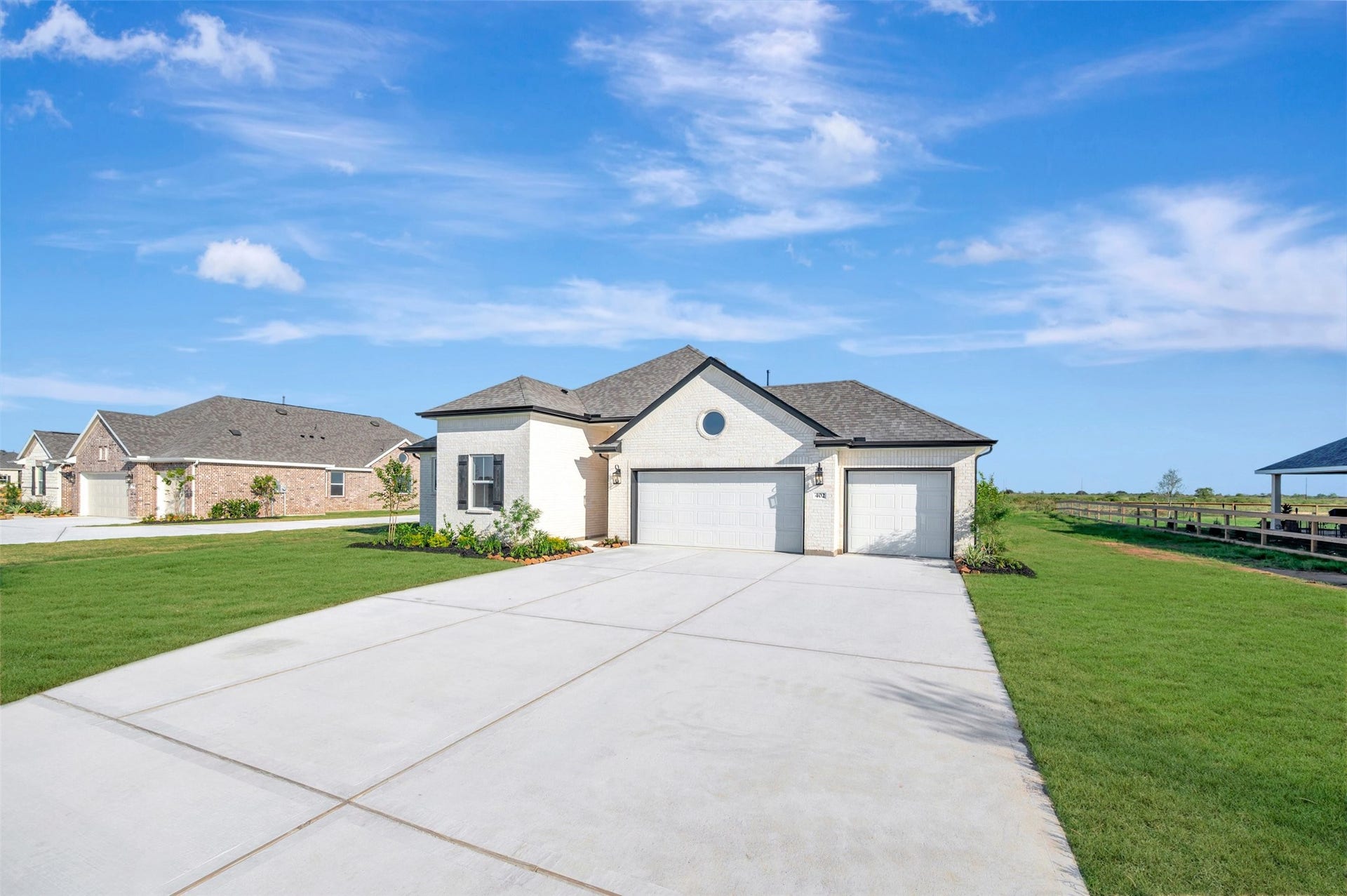 402 Cane Crossing Lake Drive, Sealy, TX 77474 One story home with 3 bedrooms, 2 baths, and 3 car garage