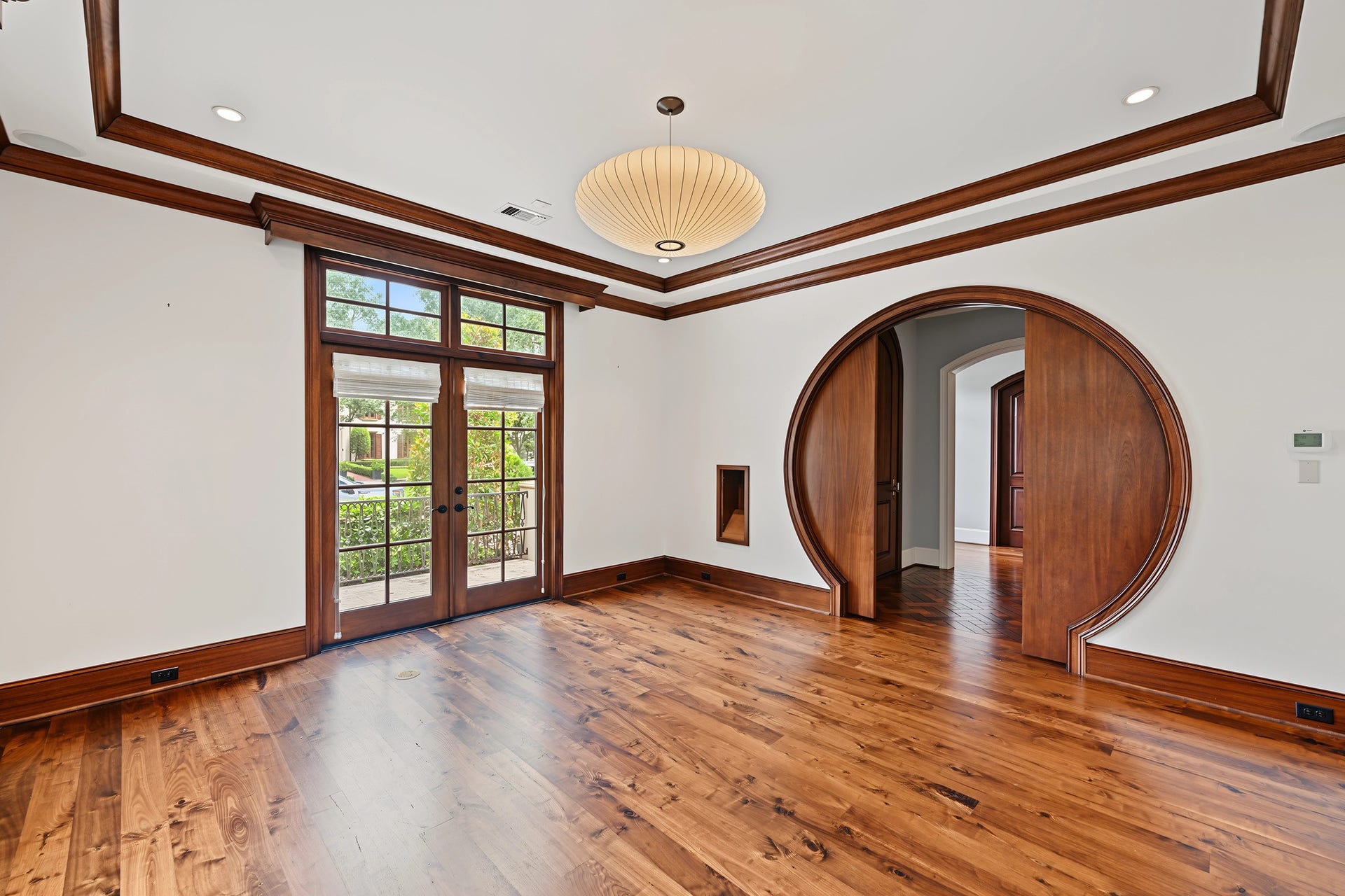 3223 Albans Road, West University Place, TX 77005 Spacious study distinguished by stunning round pocket doors, double crown molding and a tray ceiling, with French doors opening to a patio overlooking the front yard.