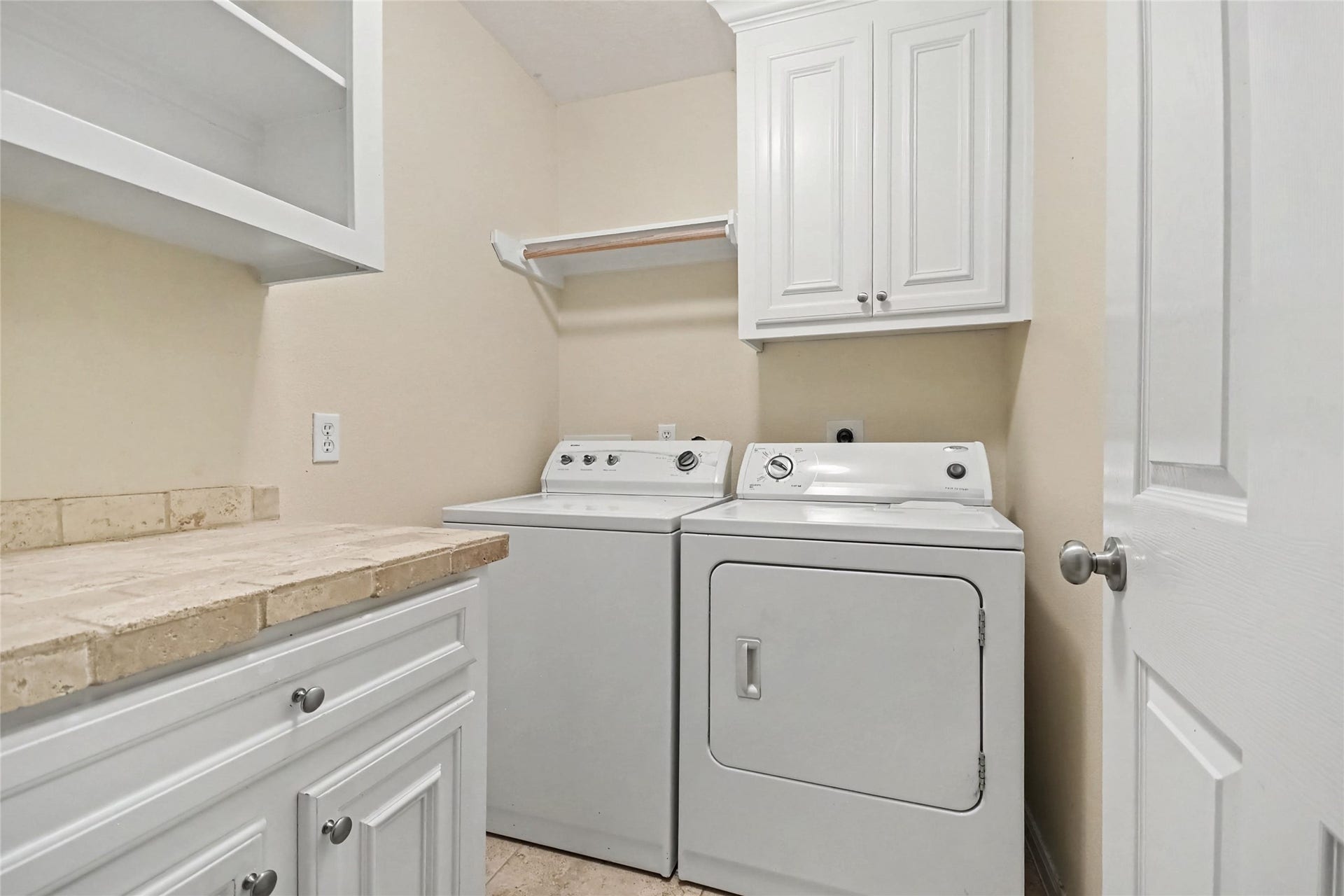 213 Rippling Creek Lane, Alvin, TX 77511 Inside laundry room has ample cabinetry and extra folding space