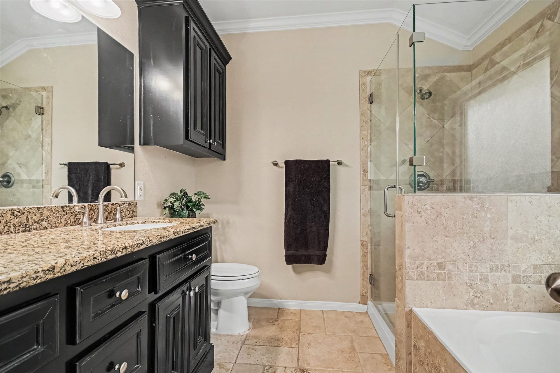 213 Rippling Creek Lane, Alvin, TX 77511 Granite double sink vanity with separate soaking tub and separate shower, all surrounded by lovely stone tile, elevated toilet