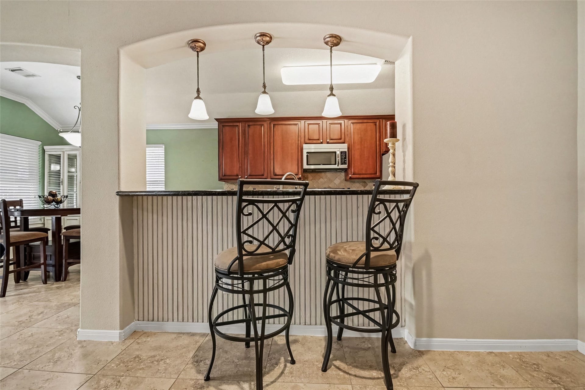213 Rippling Creek Lane, Alvin, TX 77511 Attractive beadboard accents on the bar and that matches the dining cabinet and beadboard in dining area.