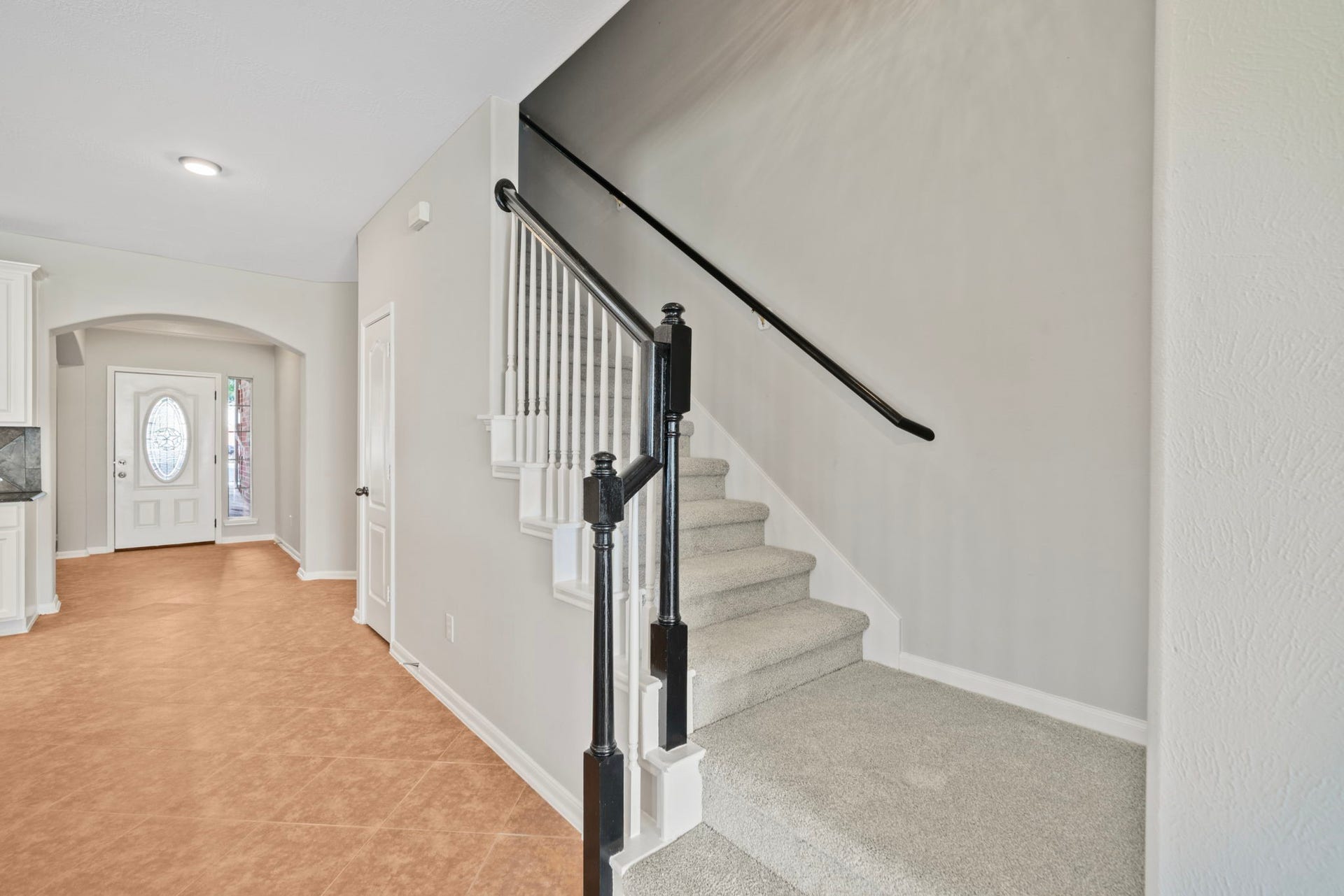 8523 Sweetstone Field Court, Cypress, TX 77433 Elegant staircase and welcoming hallway entrance.