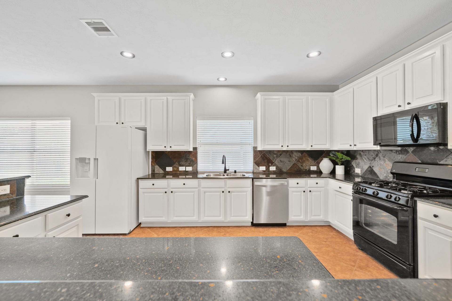8523 Sweetstone Field Court, Cypress, TX 77433 Functional kitchen featuring granite counters and modern appliances.
