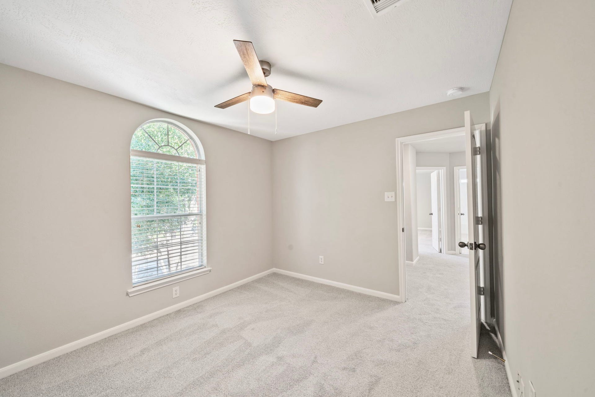 8523 Sweetstone Field Court, Cypress, TX 77433 Bright secondary bedroom with ceiling fan and natural light.