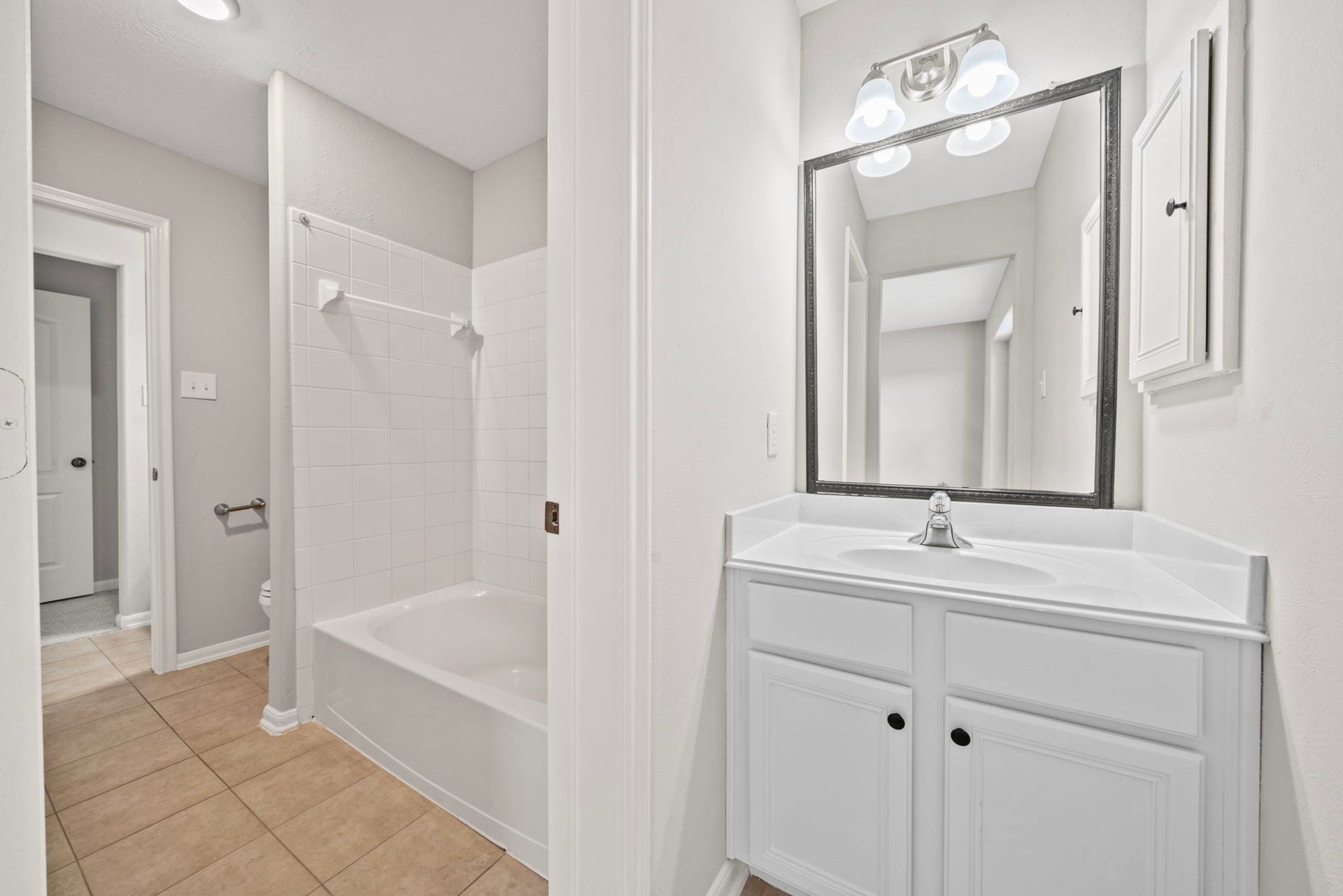 8523 Sweetstone Field Court, Cypress, TX 77433 Hollywood-style bathroom with private vanity area.
