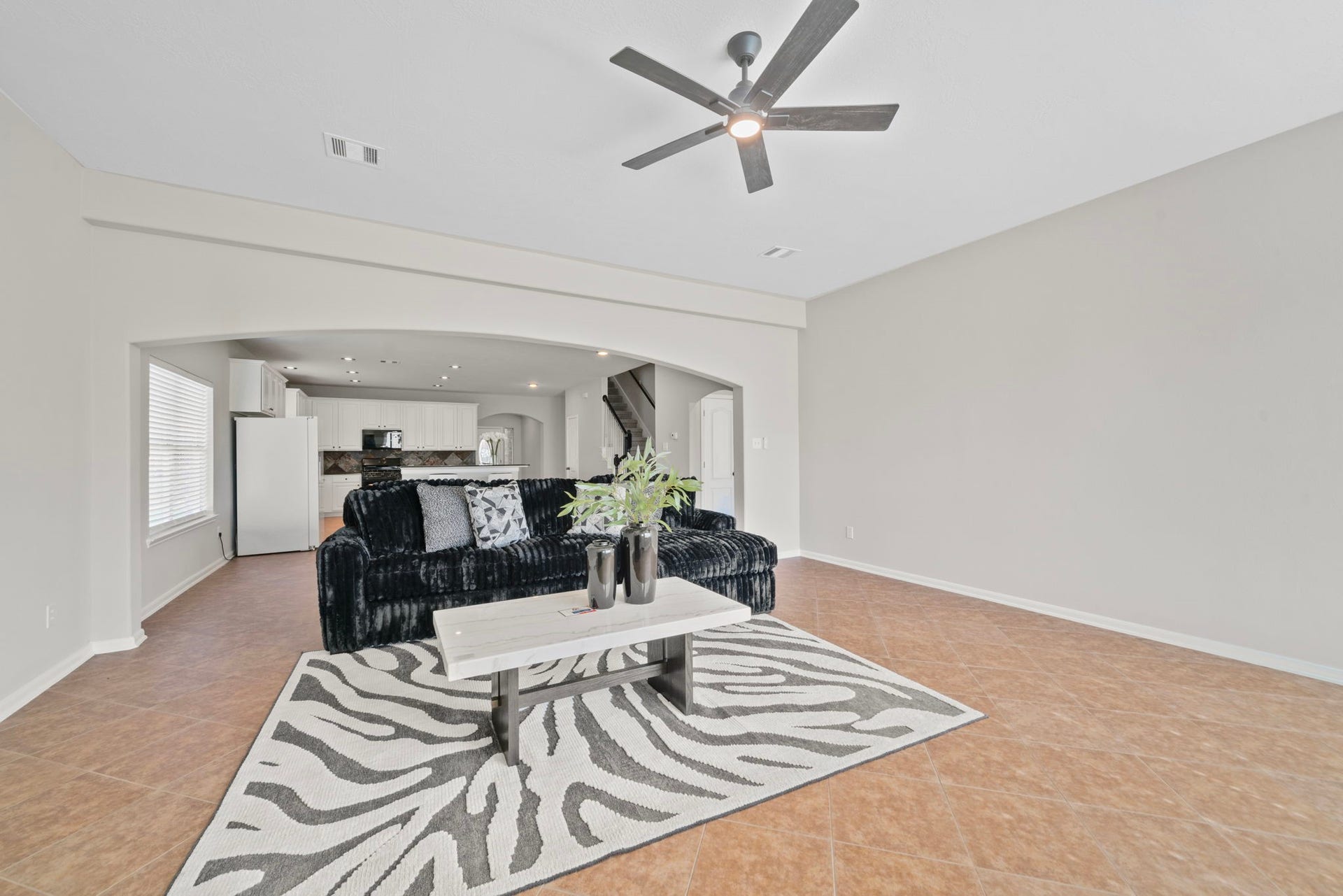 8523 Sweetstone Field Court, Cypress, TX 77433 Generous living room with plenty of space for gatherings.