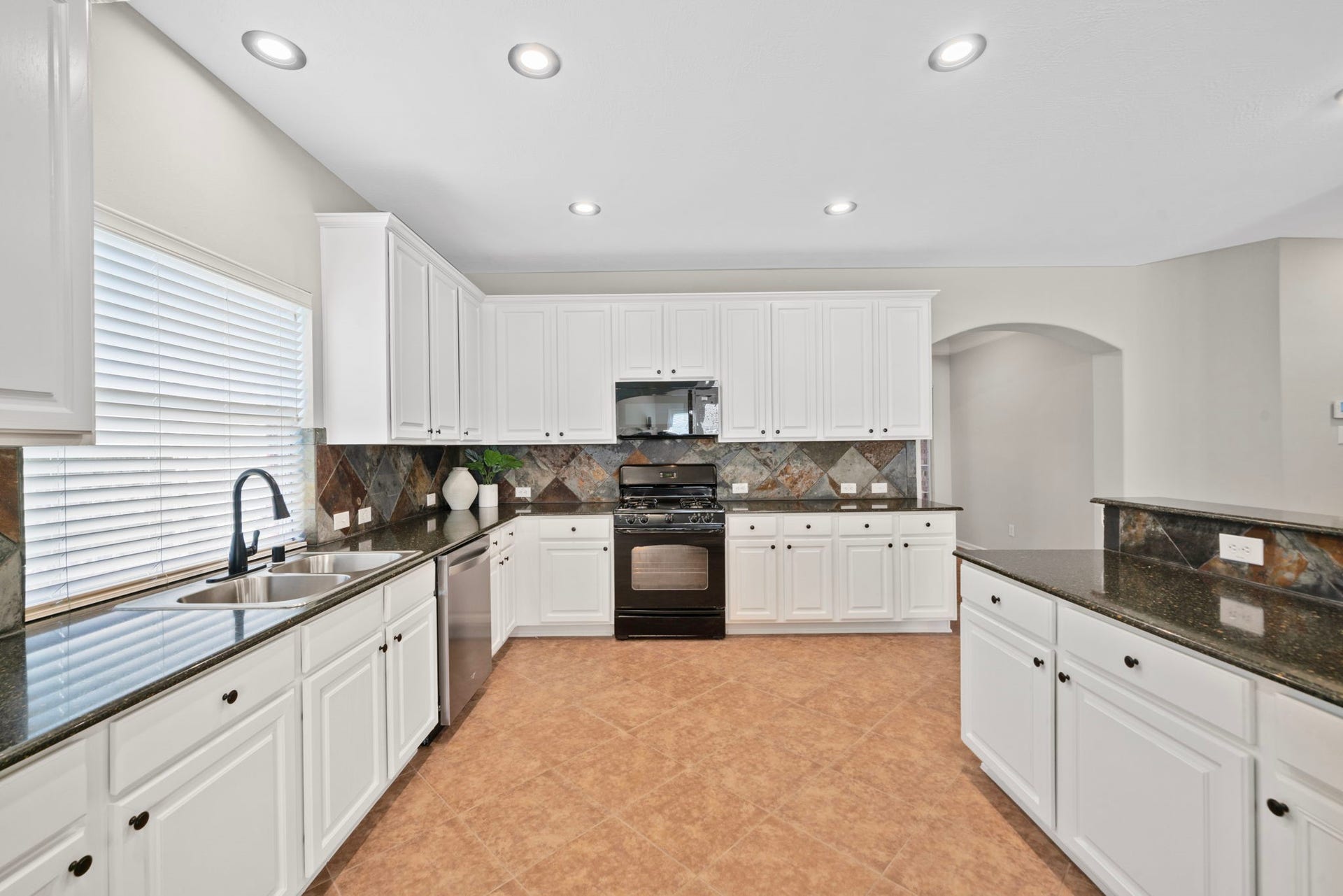 8523 Sweetstone Field Court, Cypress, TX 77433 Spacious kitchen with granite countertops and abundant cabinet space.